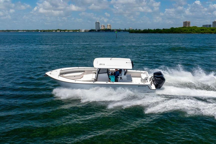 2027 Reef Runner 340 boat cruising on open water under a clear blue sky.
