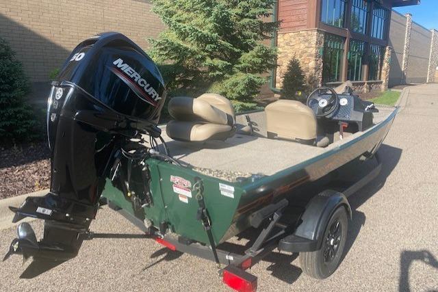 2026 Tracker Bass Tracker Classic Limited boat with Mercury outboard motor, parked outdoors.