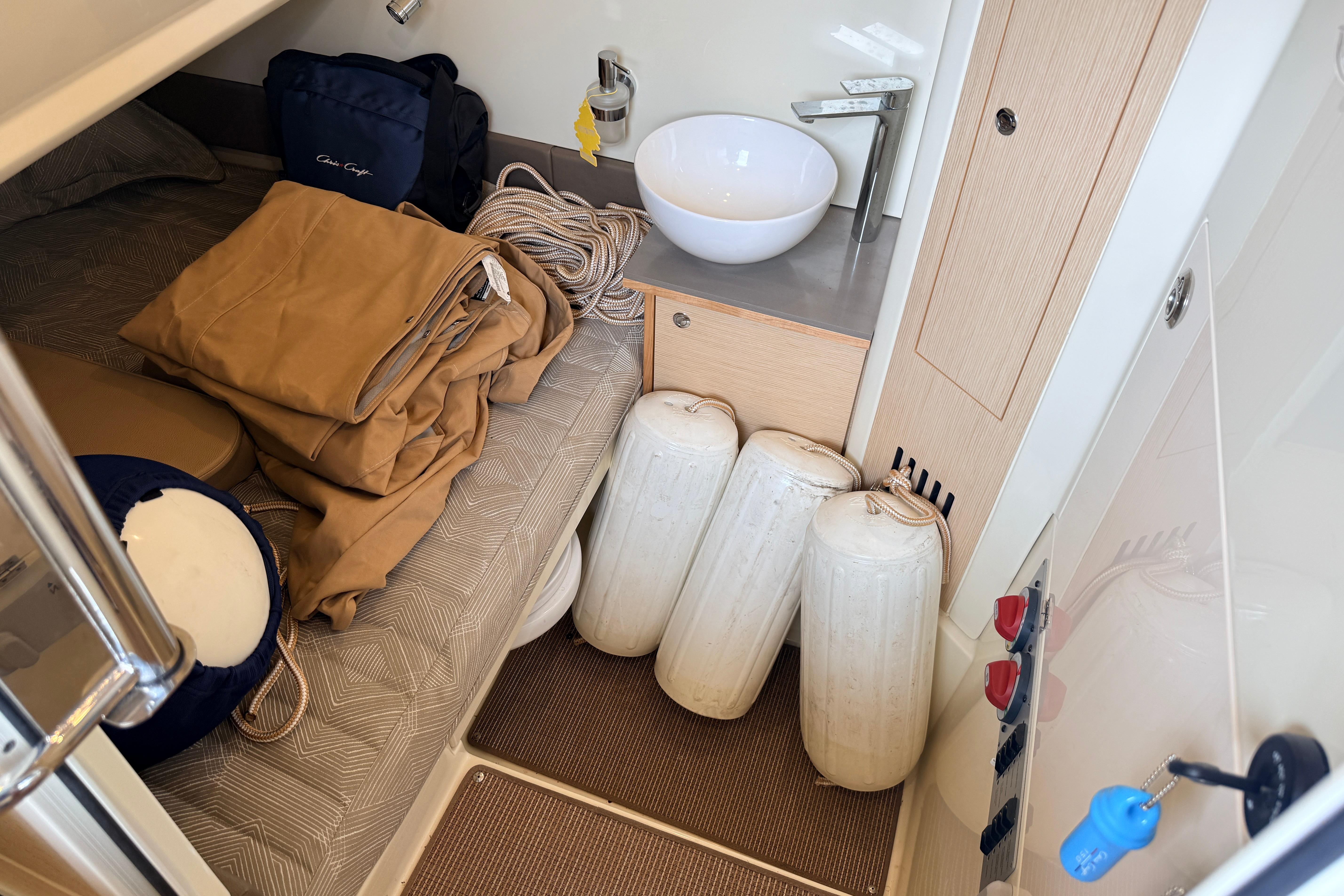2024 Chris-Craft Catalina 30 cabin interior with bed, sink, and boat accessories.