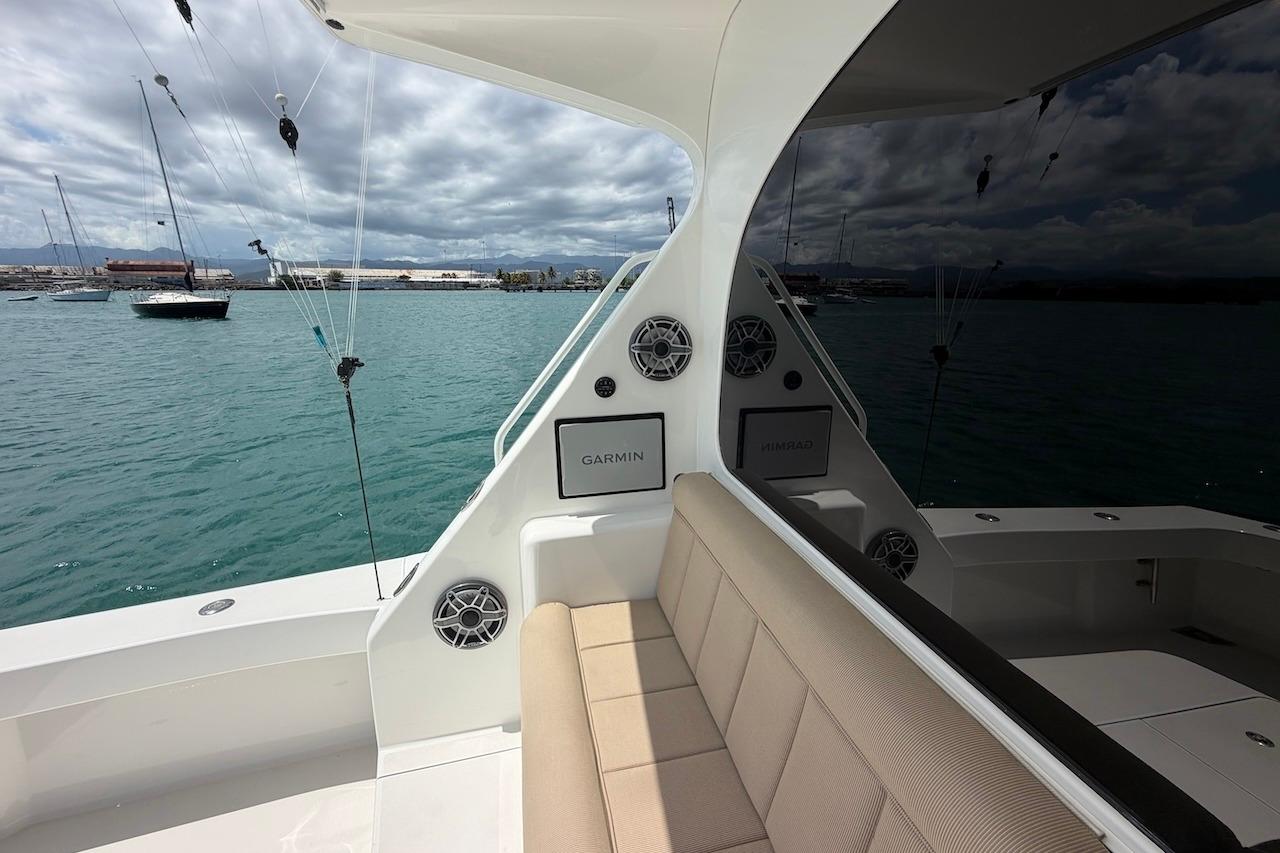 2012 Viking 50 Convertible yacht interior with seating and marine electronics, docked in a marina.