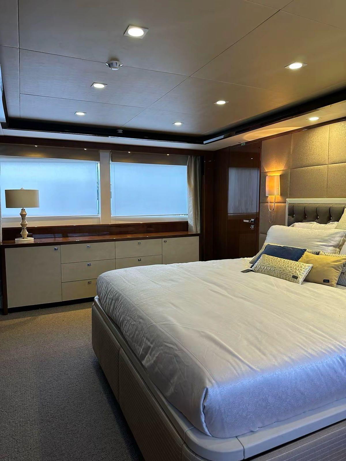 Luxurious bedroom interior on 2012 Princess M Class 32M yacht, featuring elegant decor and ambient lighting.