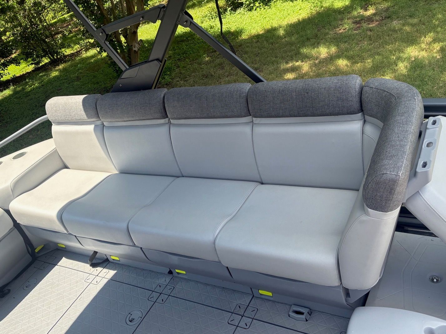 2023 Sea-Doo Switch Sport 18 with a gray cushioned sofa outdoors.