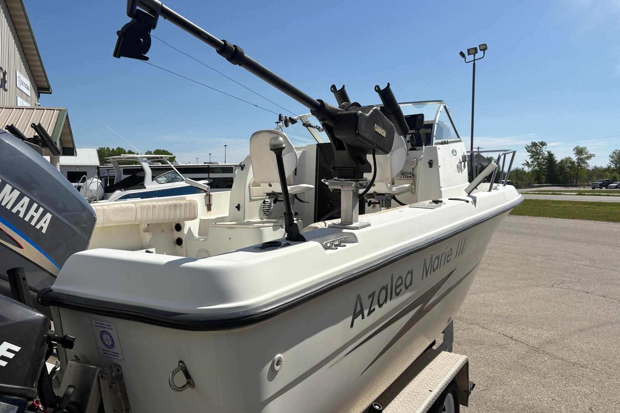2002 Hydra-Sports 212 WA boat with Yamaha engine, parked outdoors on a sunny day.
