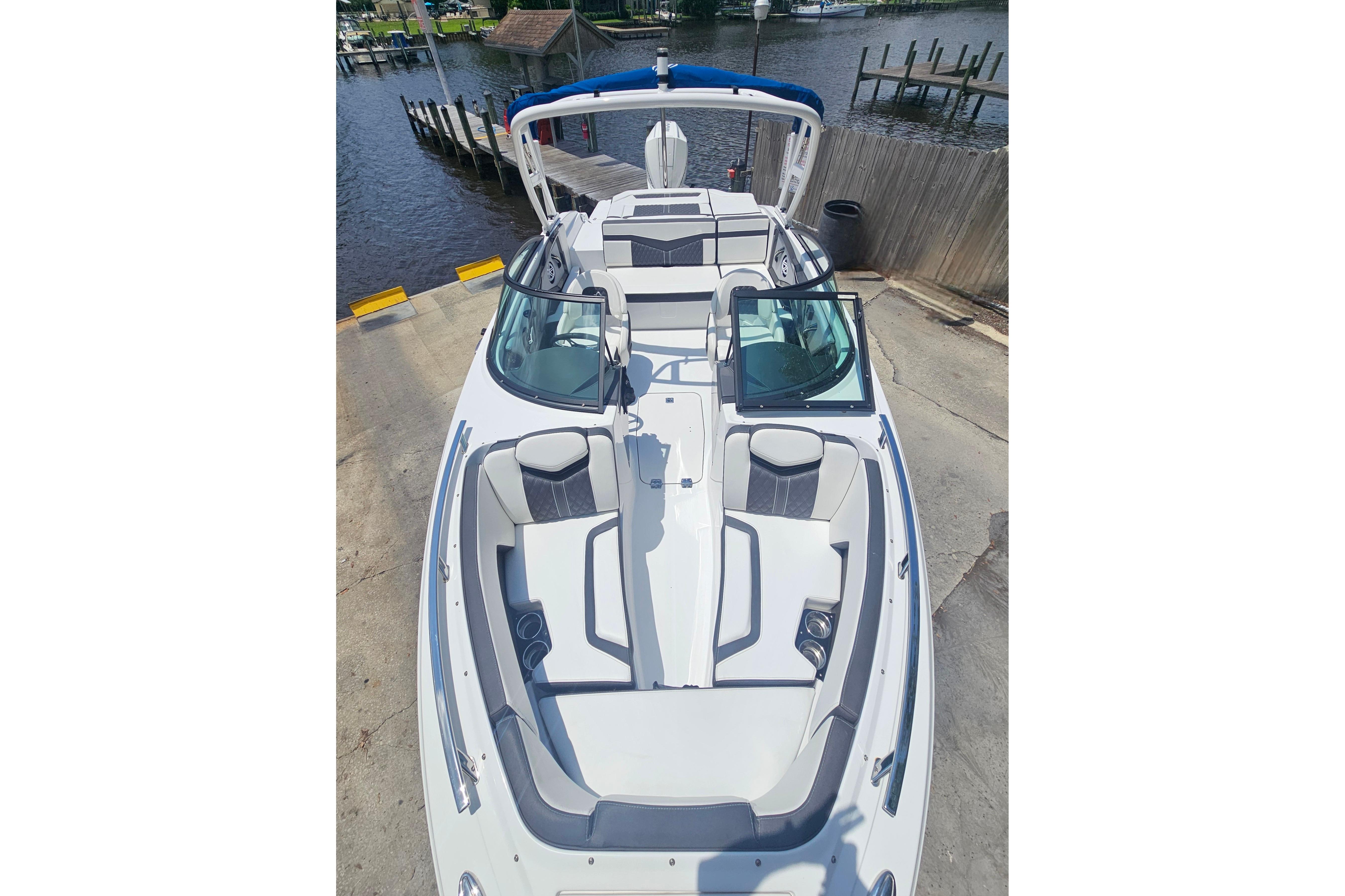 2024 Monterey 215SS Super Sport boat with sleek design and spacious seating at a dock.