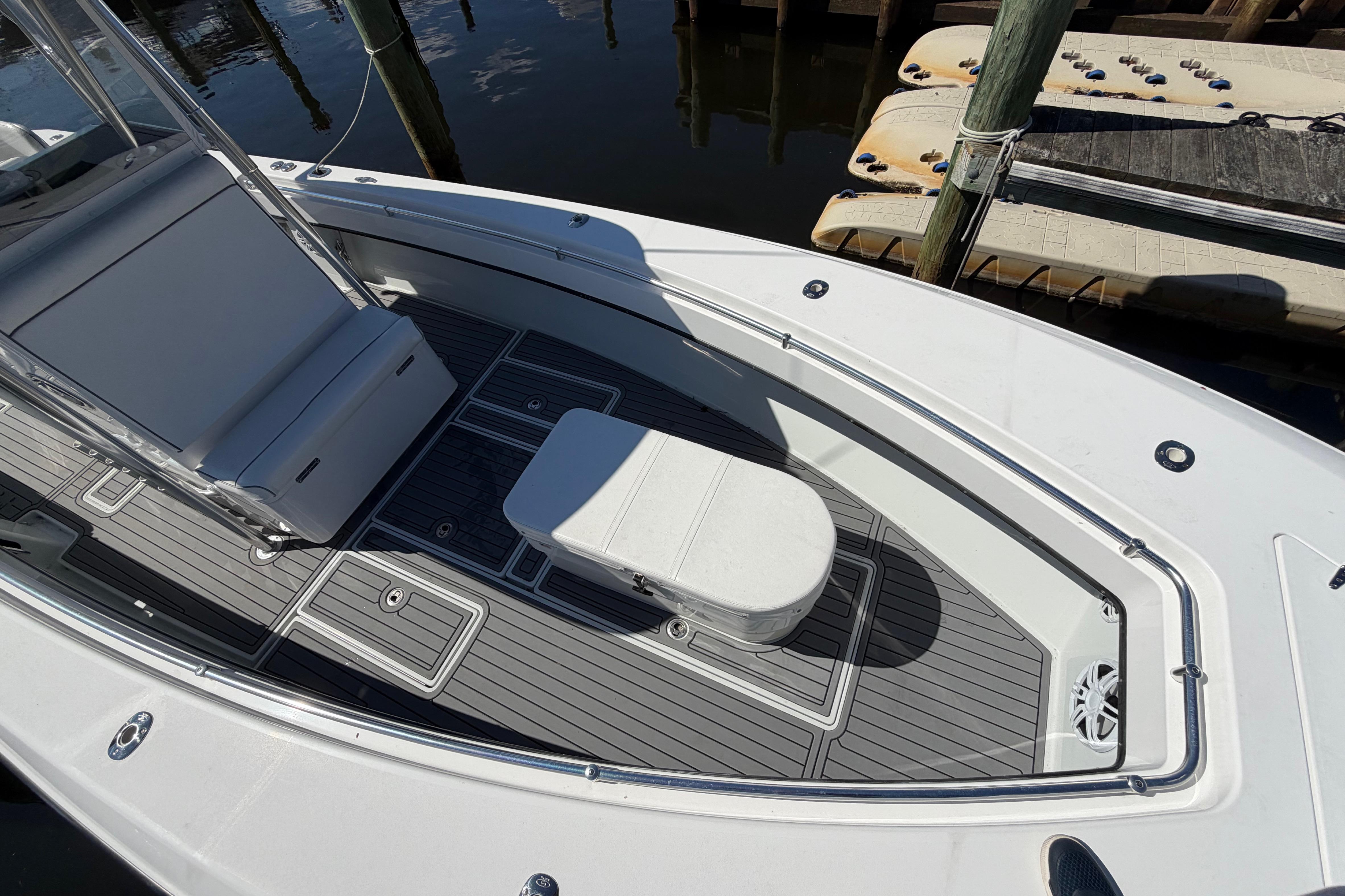2015 Contender 32 ST boat deck with seating and storage, docked at marina.
