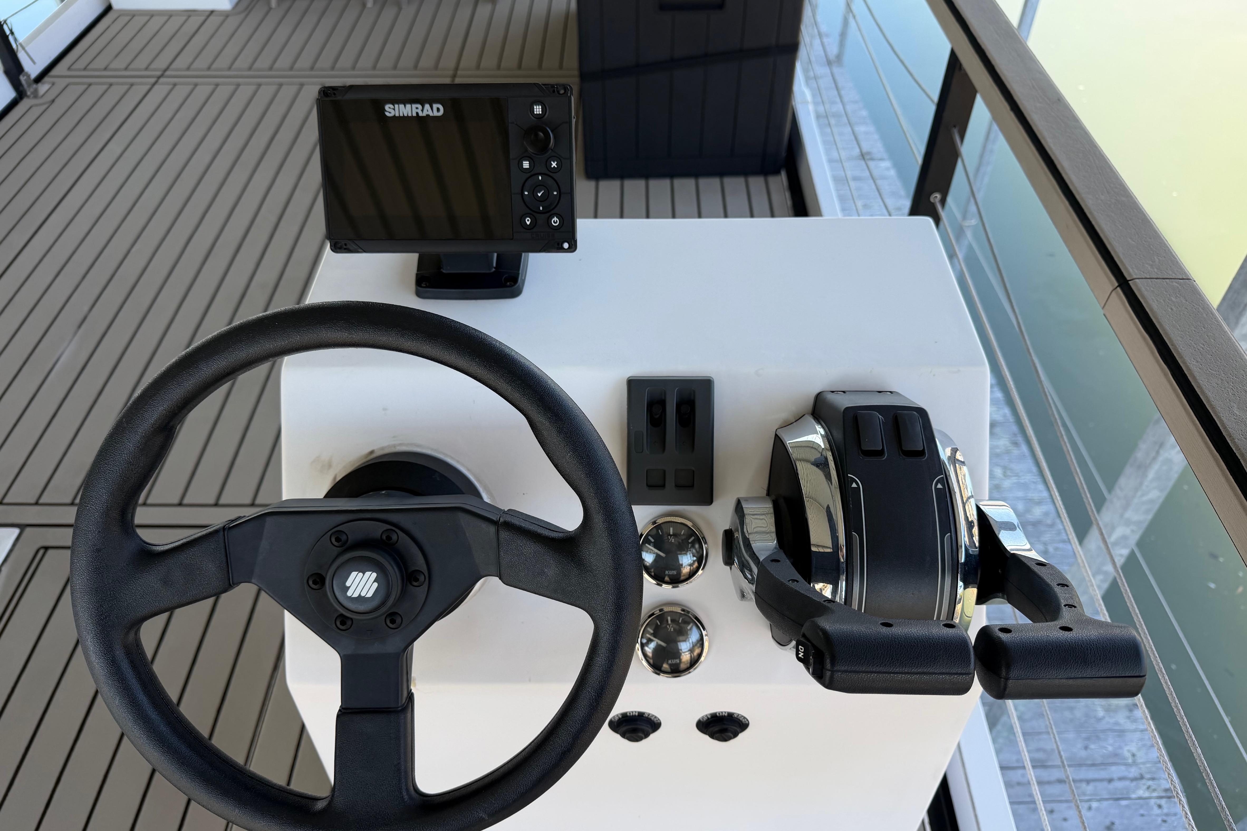 Steering console of 2022 Navisyo NV.08 with Simrad display and dual throttle controls.