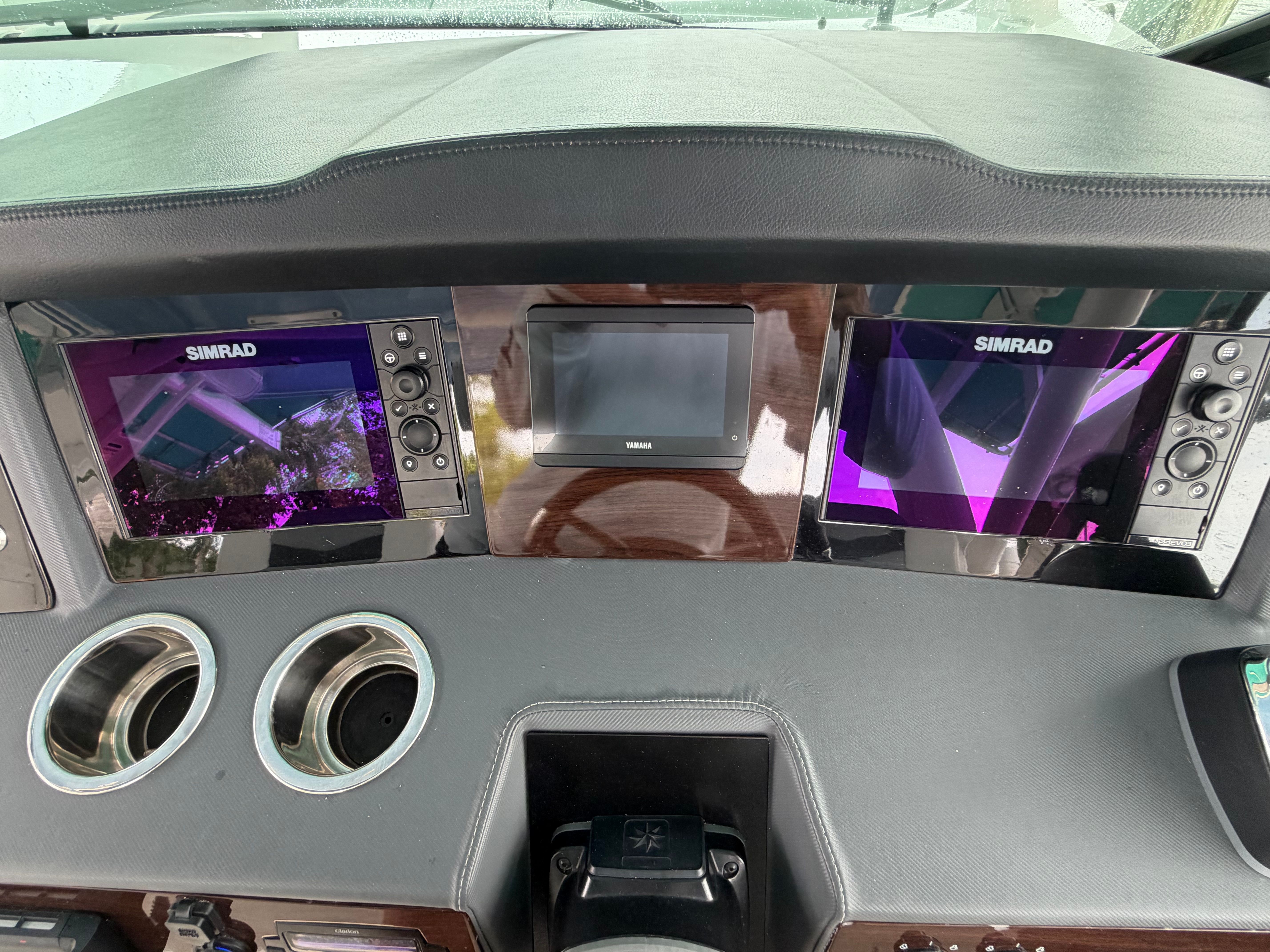 The dashboard of a Chaparral 280 OSX boat with modern Simrad screens.