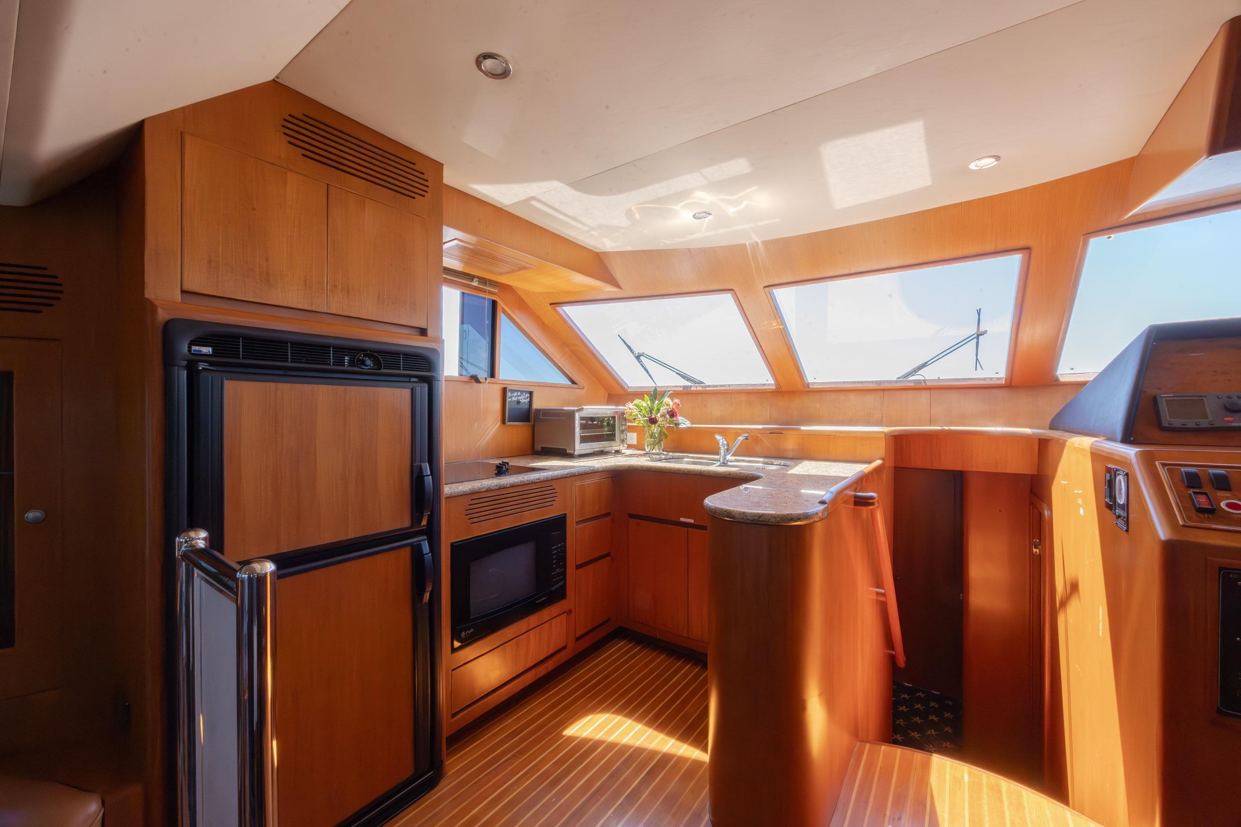 Luxurious interior of 2005 Ocean Alexander 52 Sedan yacht with modern kitchen amenities.