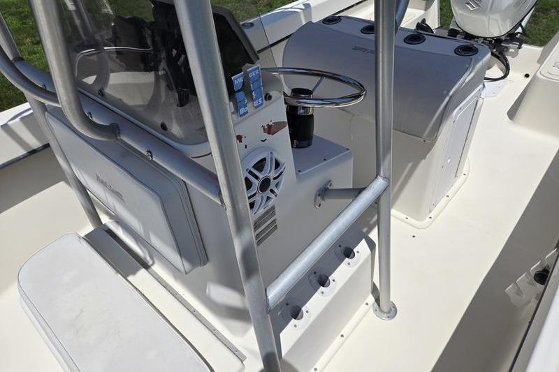 Interior view of a 2000 May-Craft 2000CC boat, featuring steering console and seating.