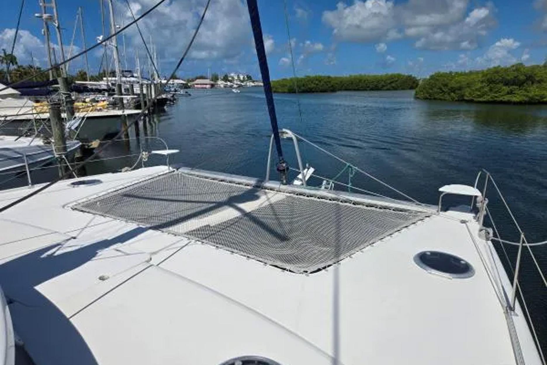 2008 Fountaine Pajot Salina 48 catamaran docked in a serene marina setting.