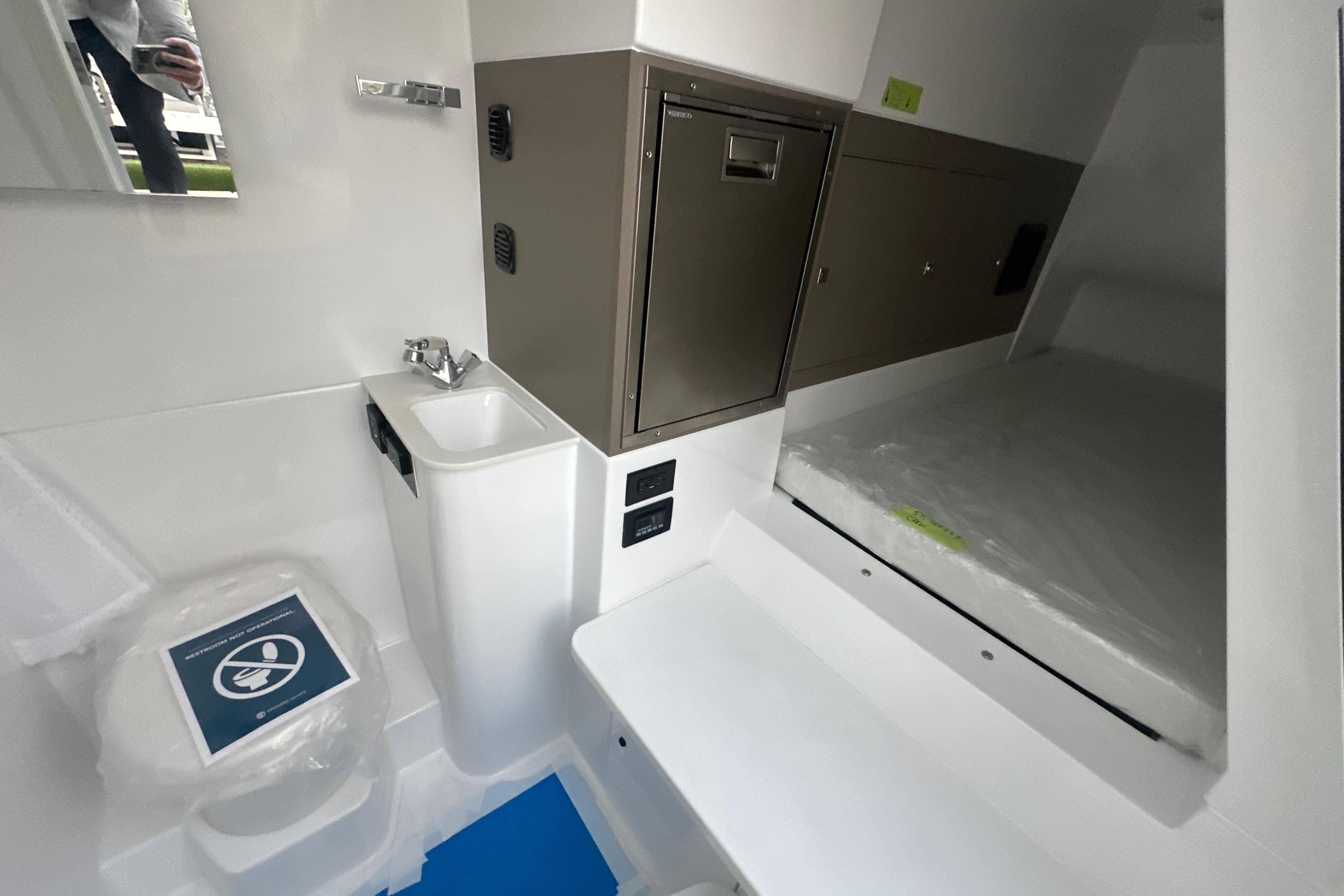 2026 Cruisers Yachts 57 Fly interior with compact bathroom and storage.