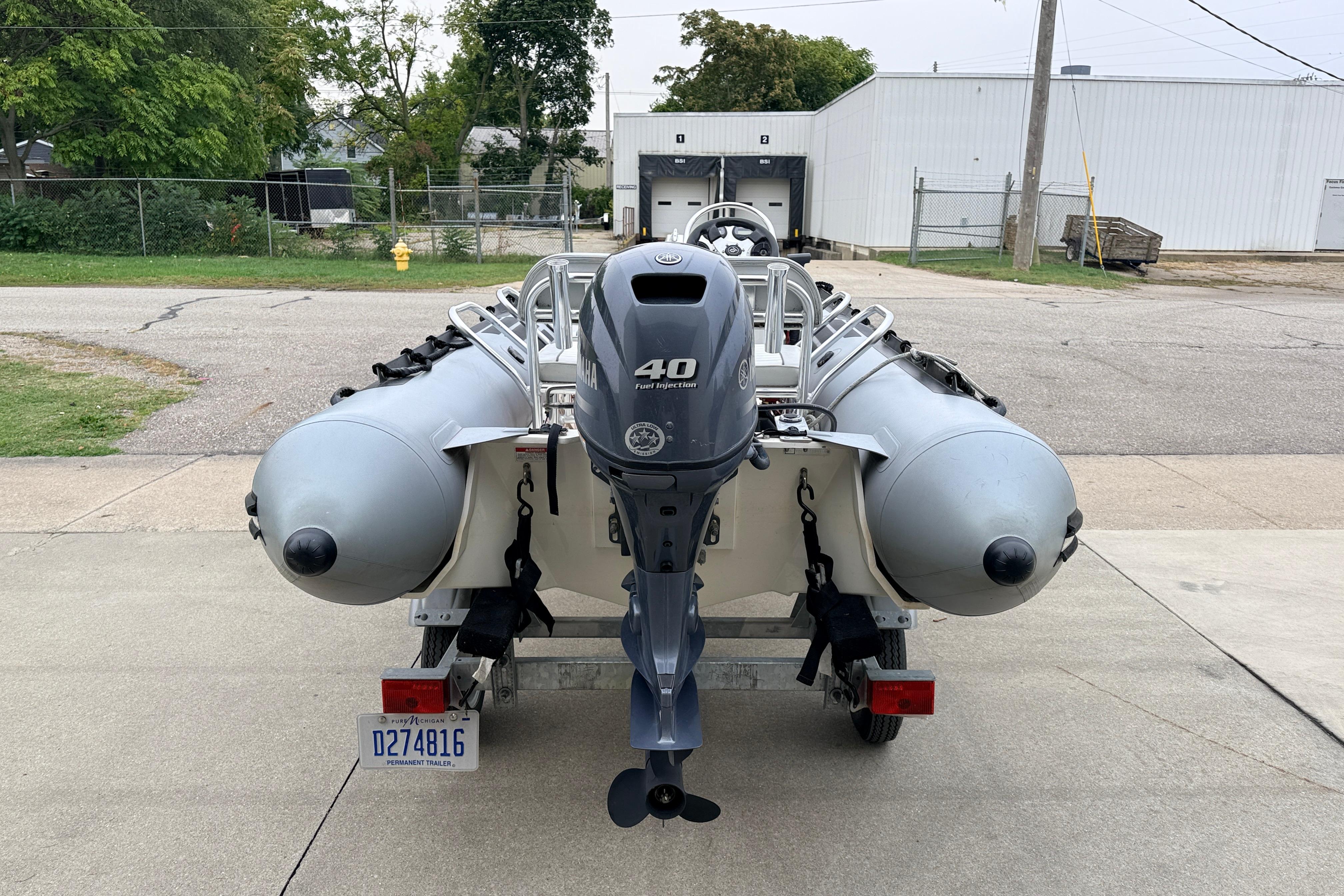 2014 Zodiac Pro Classic 420 inflatable boat with Yamaha 40 outboard motor, parked on trailer.