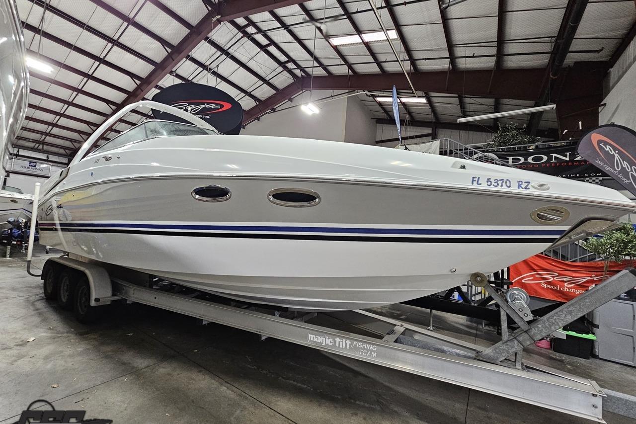 2008 Baja 335 Performance boat on trailer in indoor showroom.