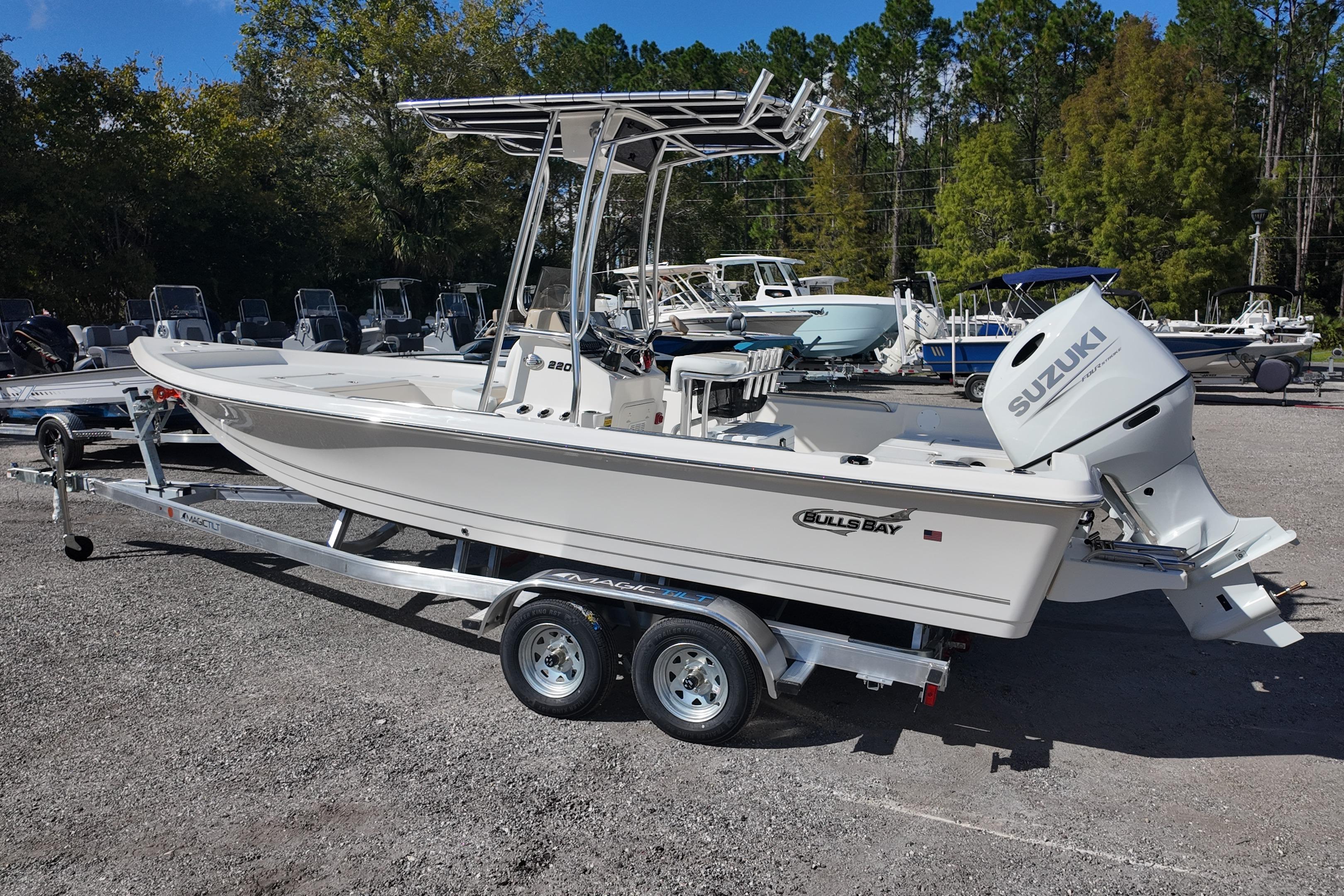 2026 Bulls Bay 2200 boat on trailer with Suzuki outboard motor, parked outdoors.