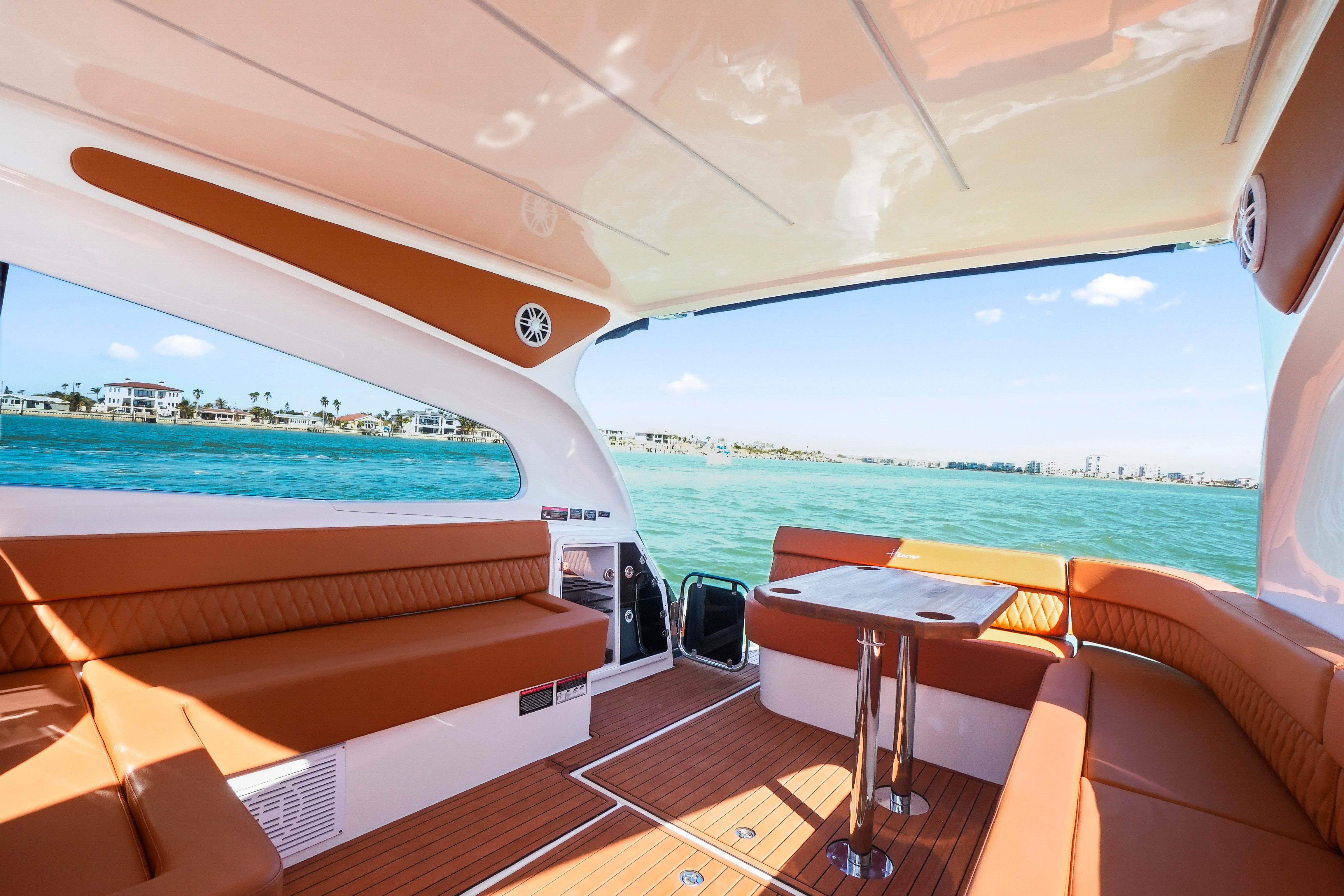Luxurious interior of 2026 Hanover 355 boat with ocean view and elegant seating.