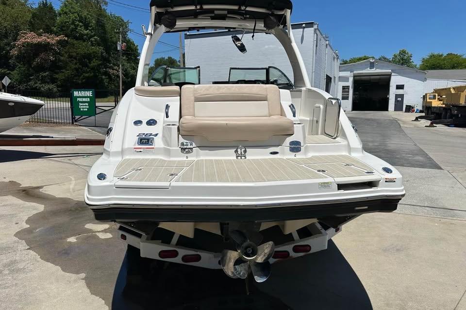 2012 Chaparral 284 Sunesta boat rear view at a marina, showcasing swim platform and seating.