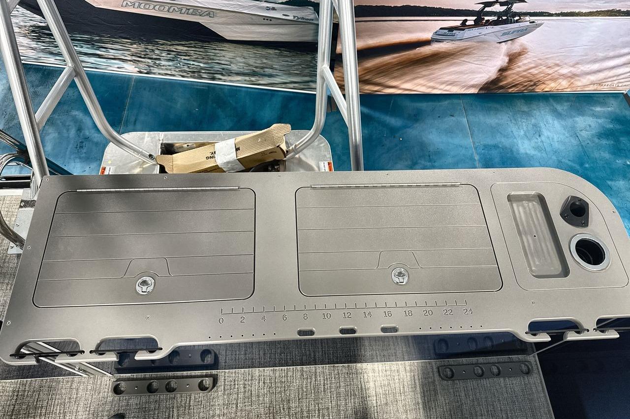 Fishing station on 2026 Landau Island Breeze 23F pontoon boat with storage and cup holders.