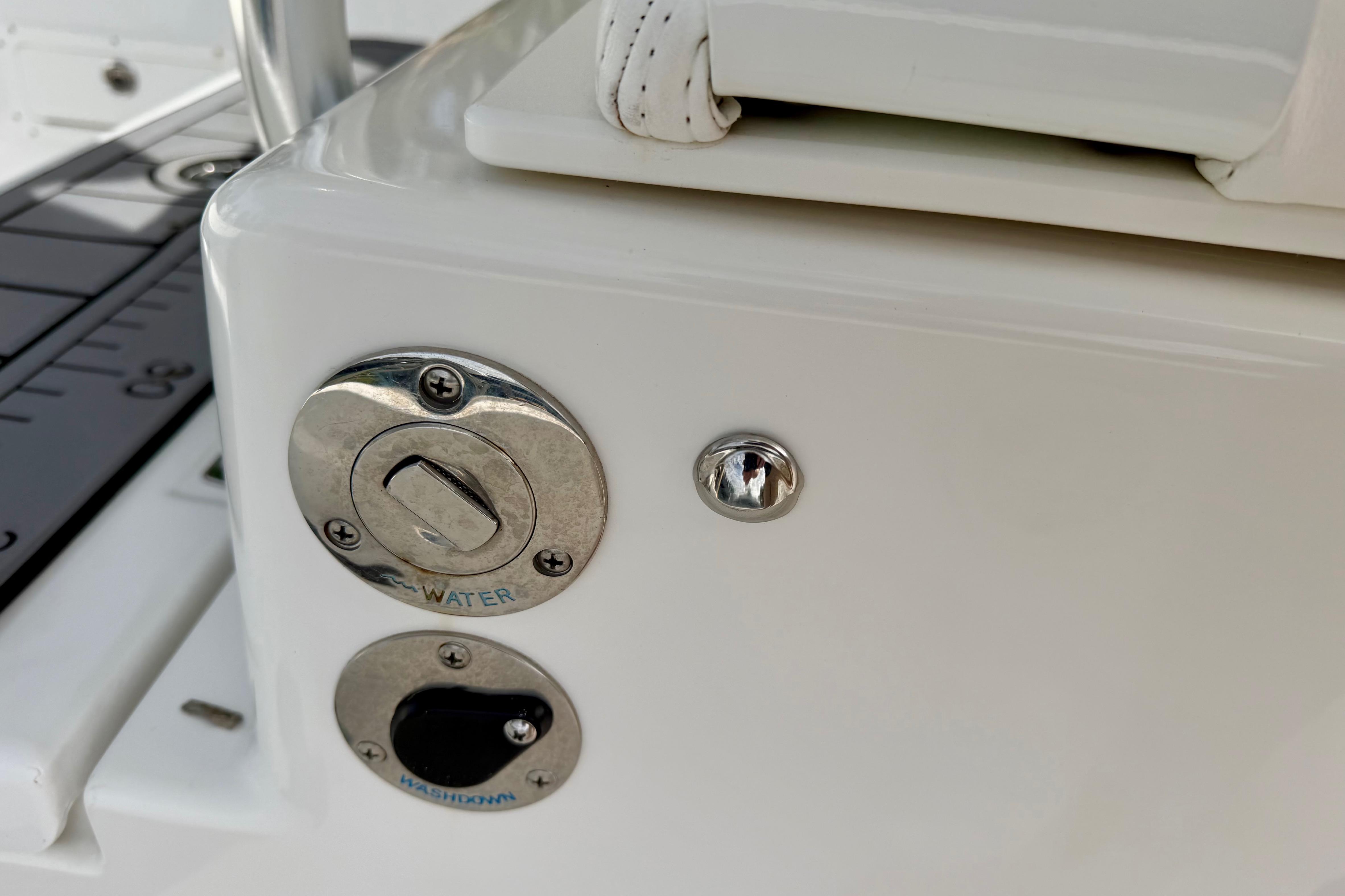 Close-up of 2025 Ocean Master 296 Center Console water and washdown controls.