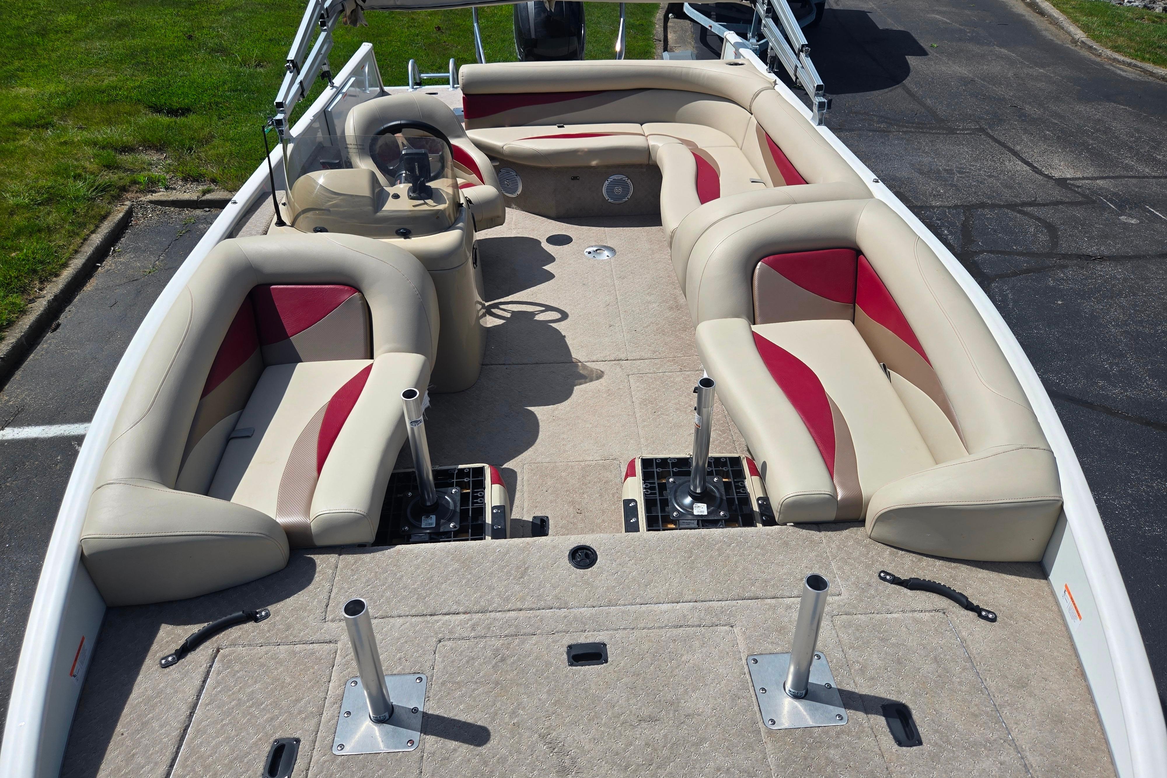2015 Lowe Sport Deck 224 boat interior with beige and red seating, spacious layout.