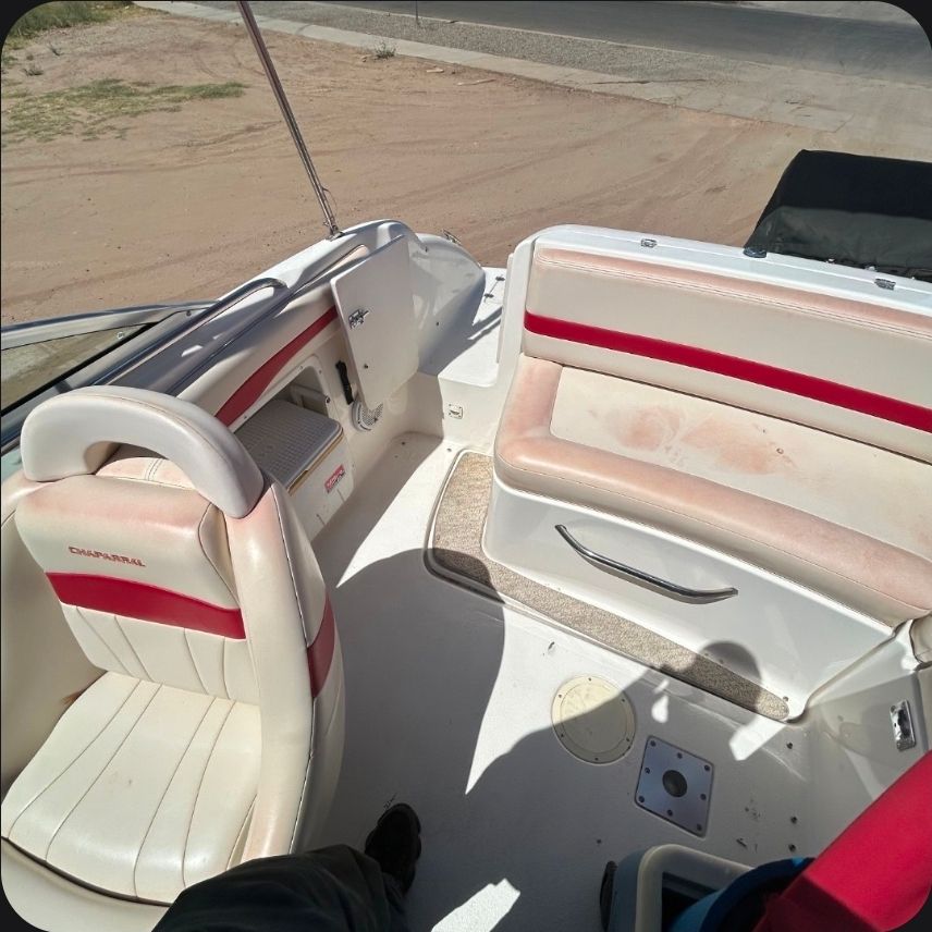 Interior of a 2001 Chaparral Sunesta 233 boat with red accents.