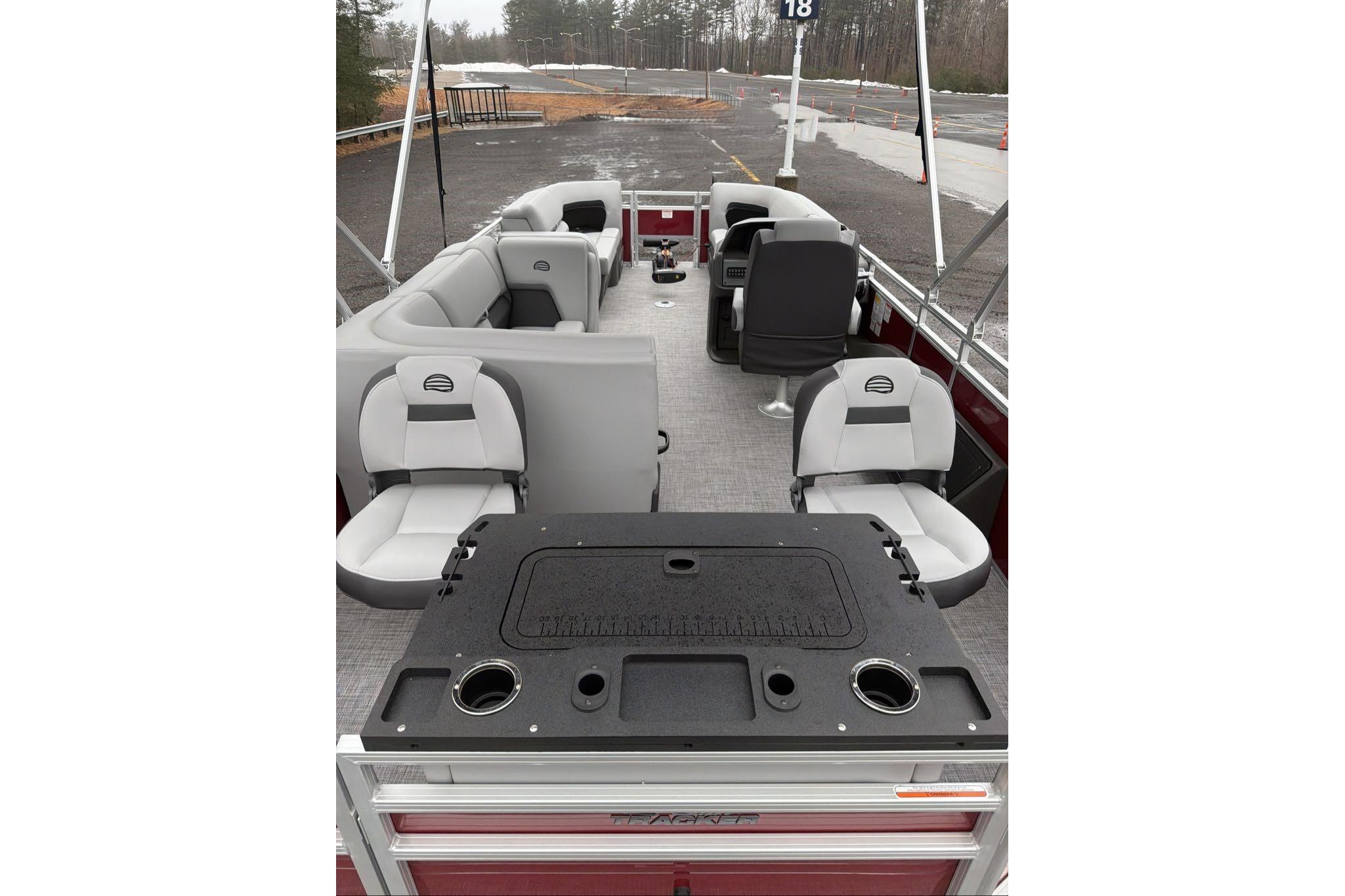 2026 Sun Tracker SportFish 22 DLX pontoon boat interior with seating and fishing station.