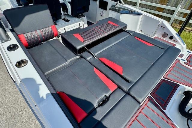2026 Monterey Elite 25 OB boat interior with black and red seating, showcasing luxury design.