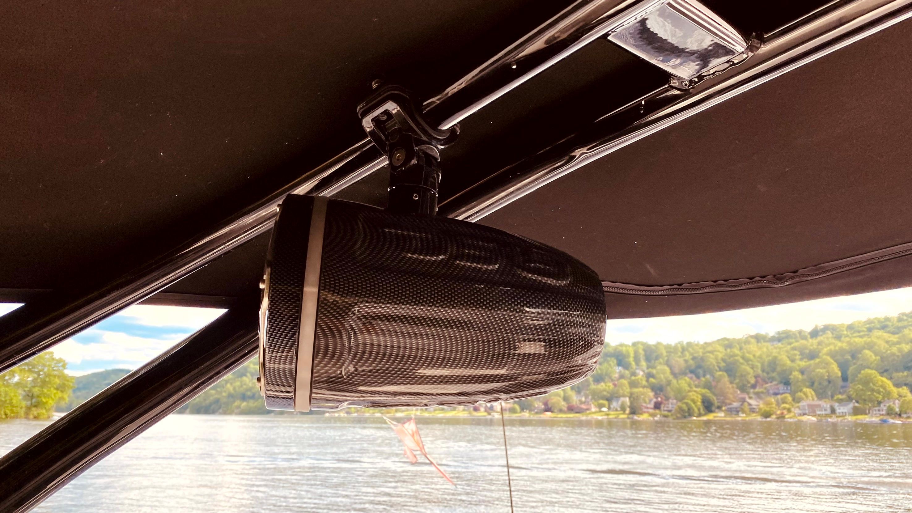 Speaker on Yamaha AR240 boat, overlooking lake and trees.