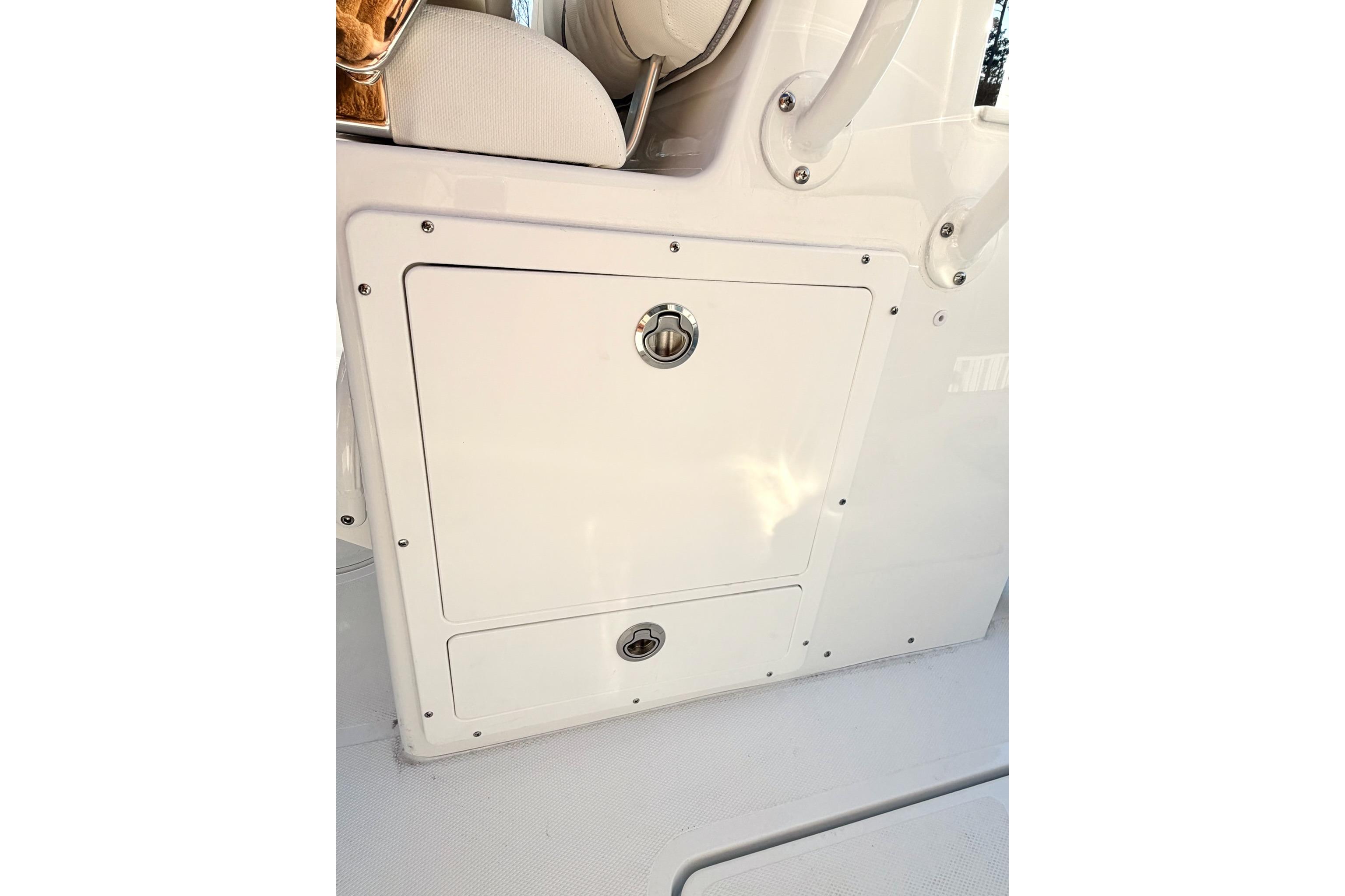 2026 Sea Hunt Ultra 275 Coffin Box storage compartment with secure latch and sleek design.
