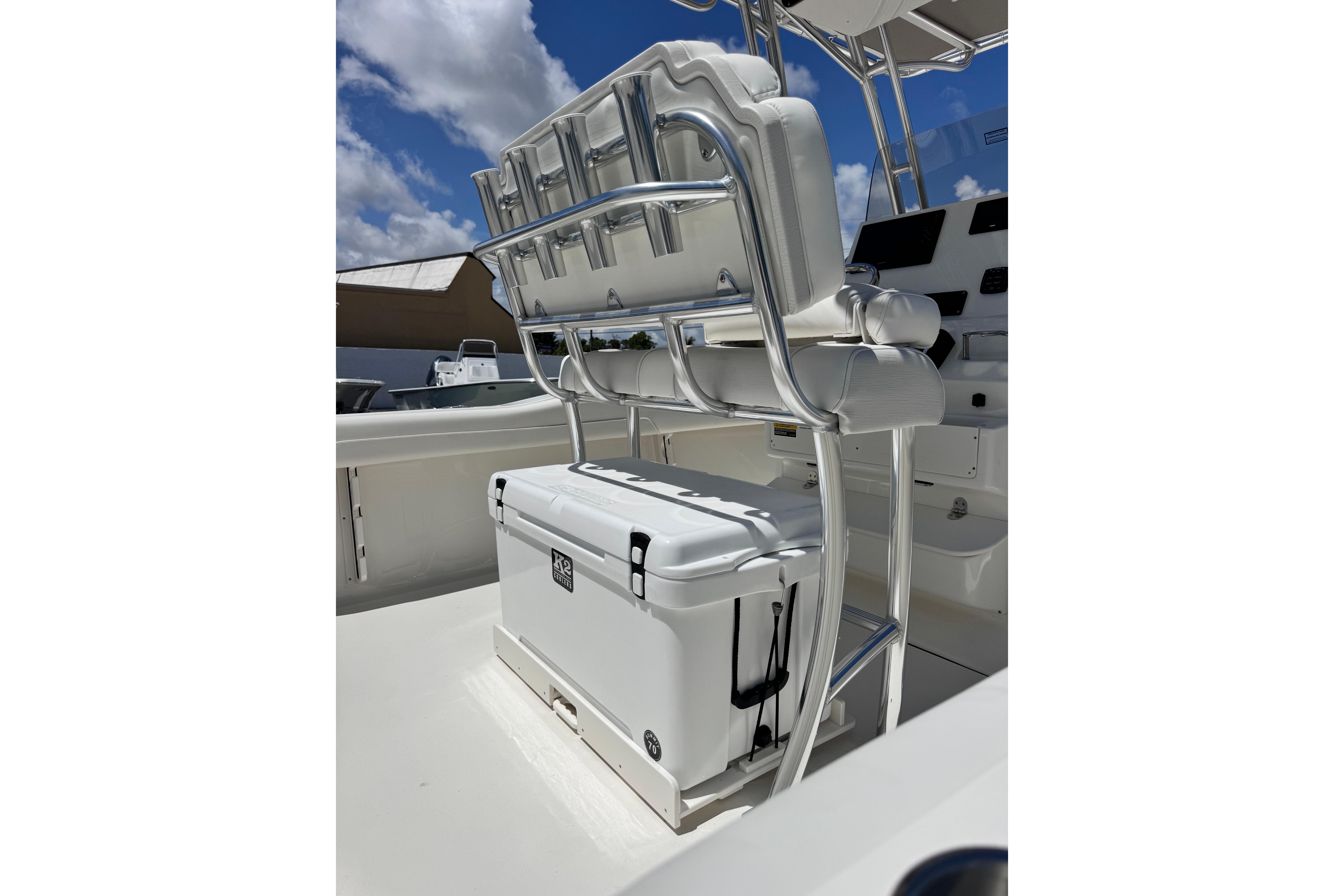 2026 Key West 219 FS boat interior with seating and cooler under a sunny sky.