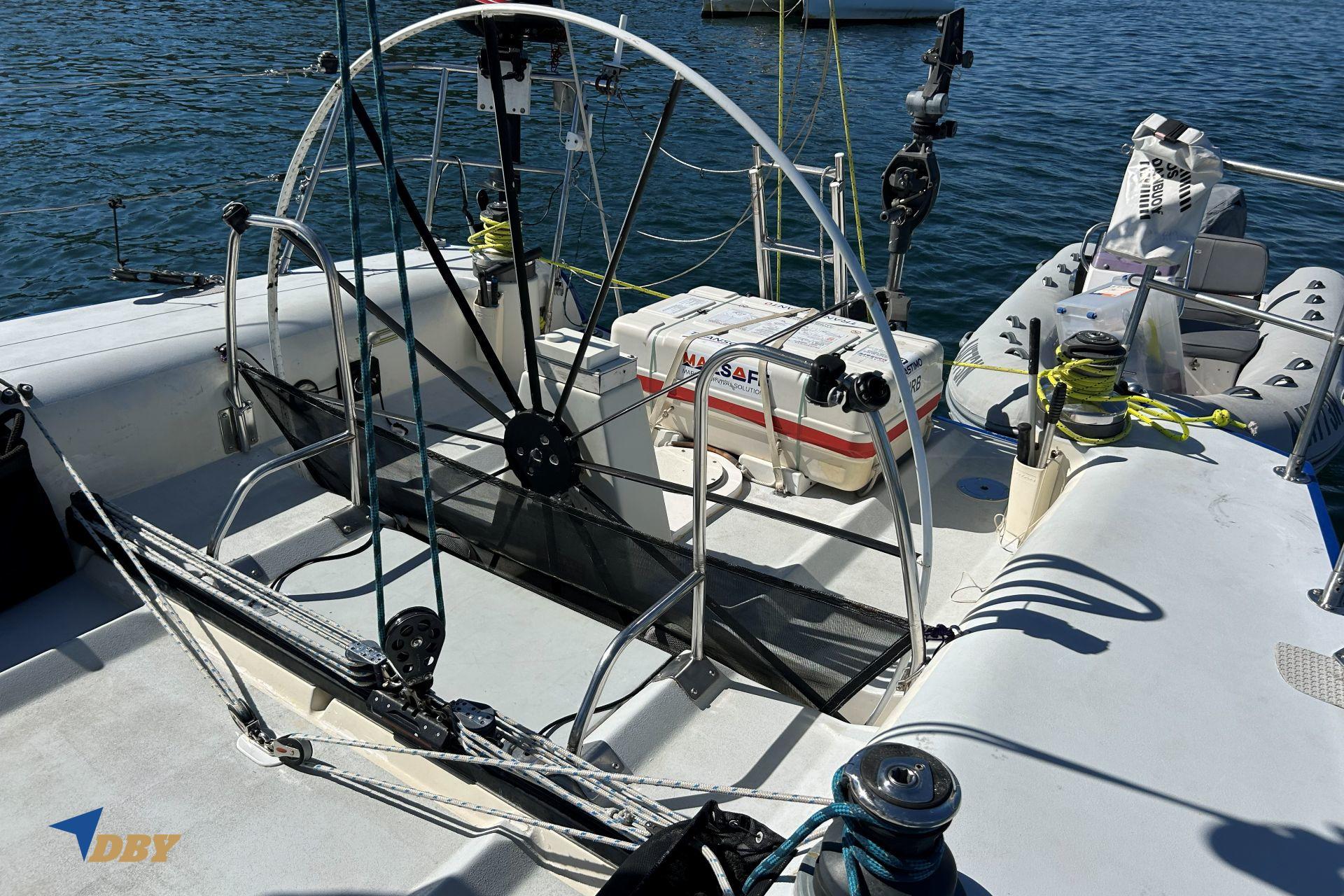 Sailboat cockpit of 1992 Bill Tripp 47, featuring steering wheel and safety equipment.