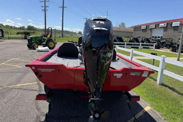 2026 Tracker Pro Team 175 boat with outboard motor, parked outdoors on a sunny day.