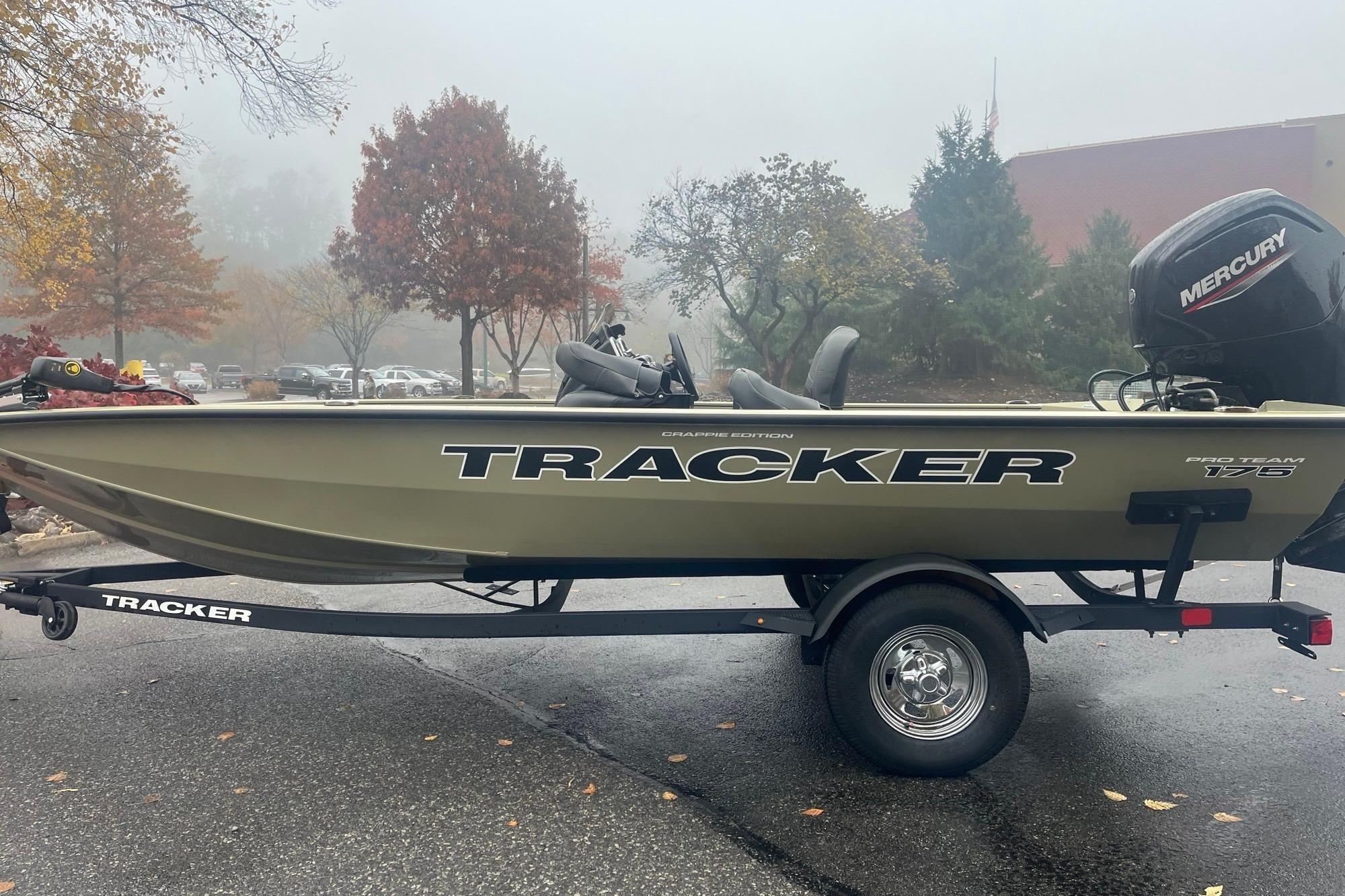 2026 Tracker Pro Team 175 Crappie Edition boat on trailer, parked outdoors.