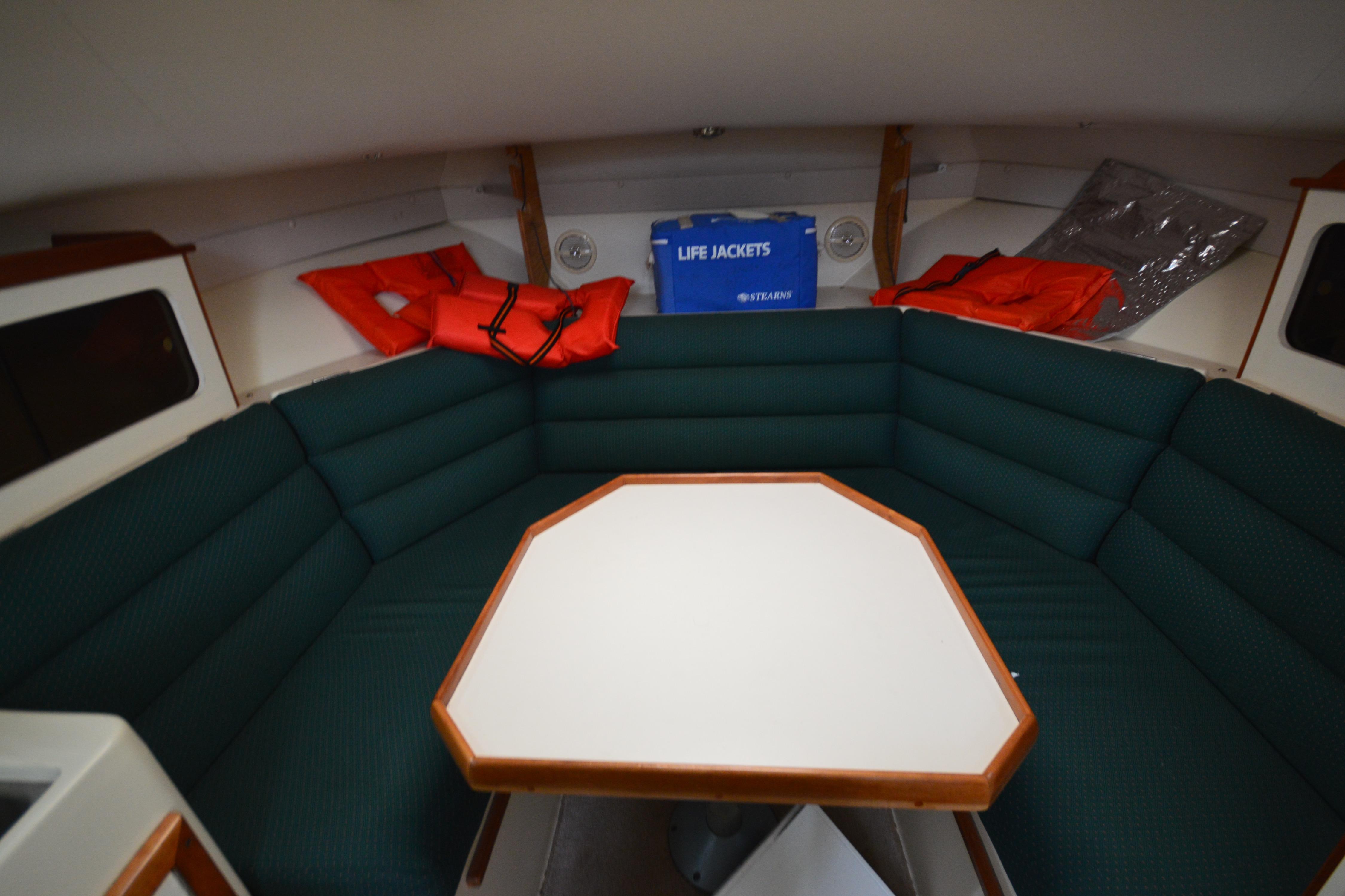 Interior of 2001 Albin 28 Tournament Express with seating, table, and life jackets.