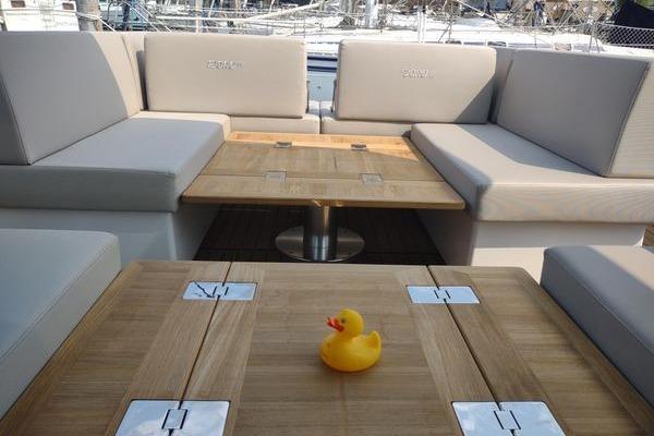 2023 Fjord 41 XL yacht interior with wooden tables and a rubber duck.