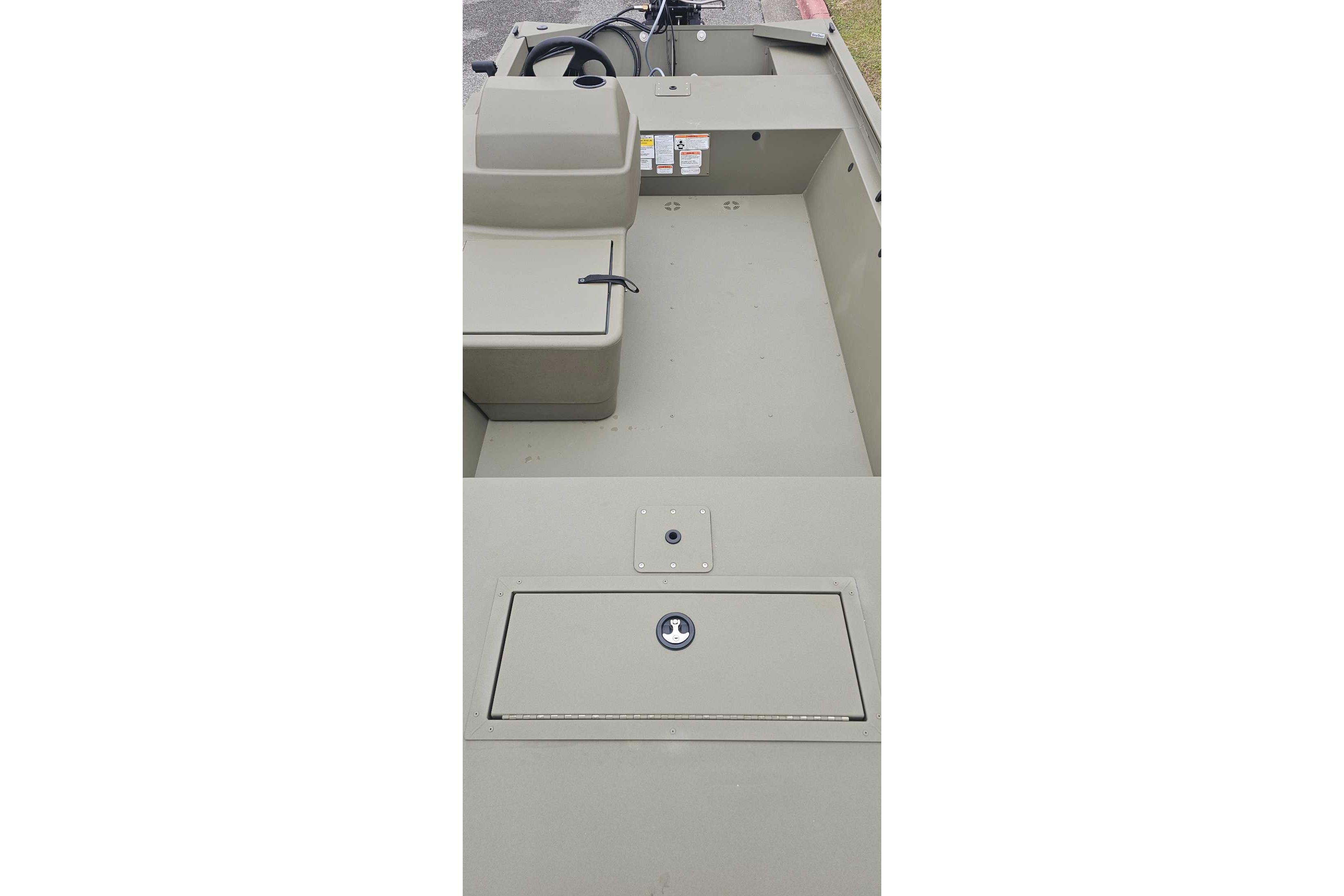 2026 Tracker Grizzly 1648 SC boat interior with storage compartments and steering console.