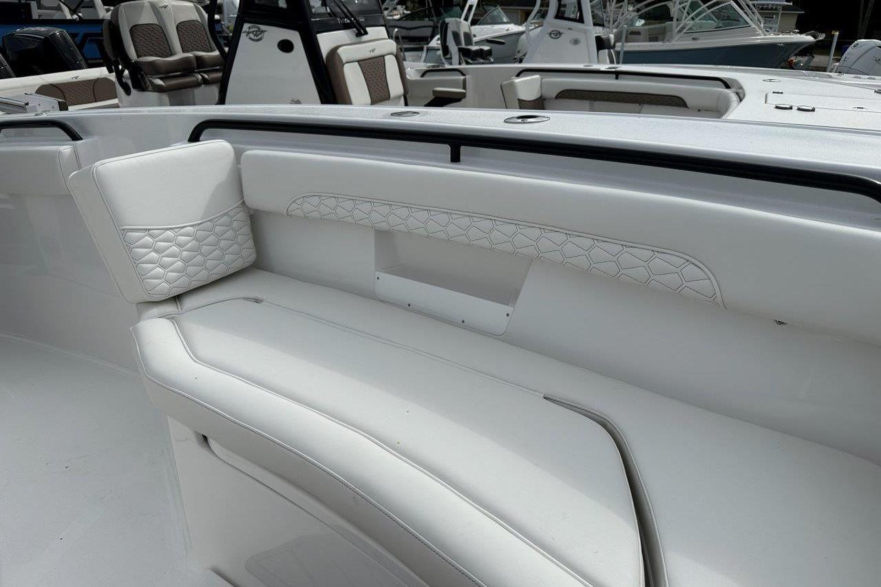 2026 Tidewater 272 LXF boat interior with white cushioned seating and elegant design.