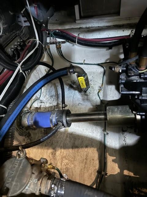Engine compartment of a 2001 Carver 396 Motoryacht, showing mechanical components and hoses.