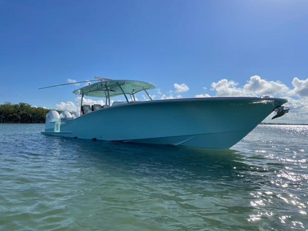 2025 Mag Bay 43 Center Console boat on clear water under blue sky.