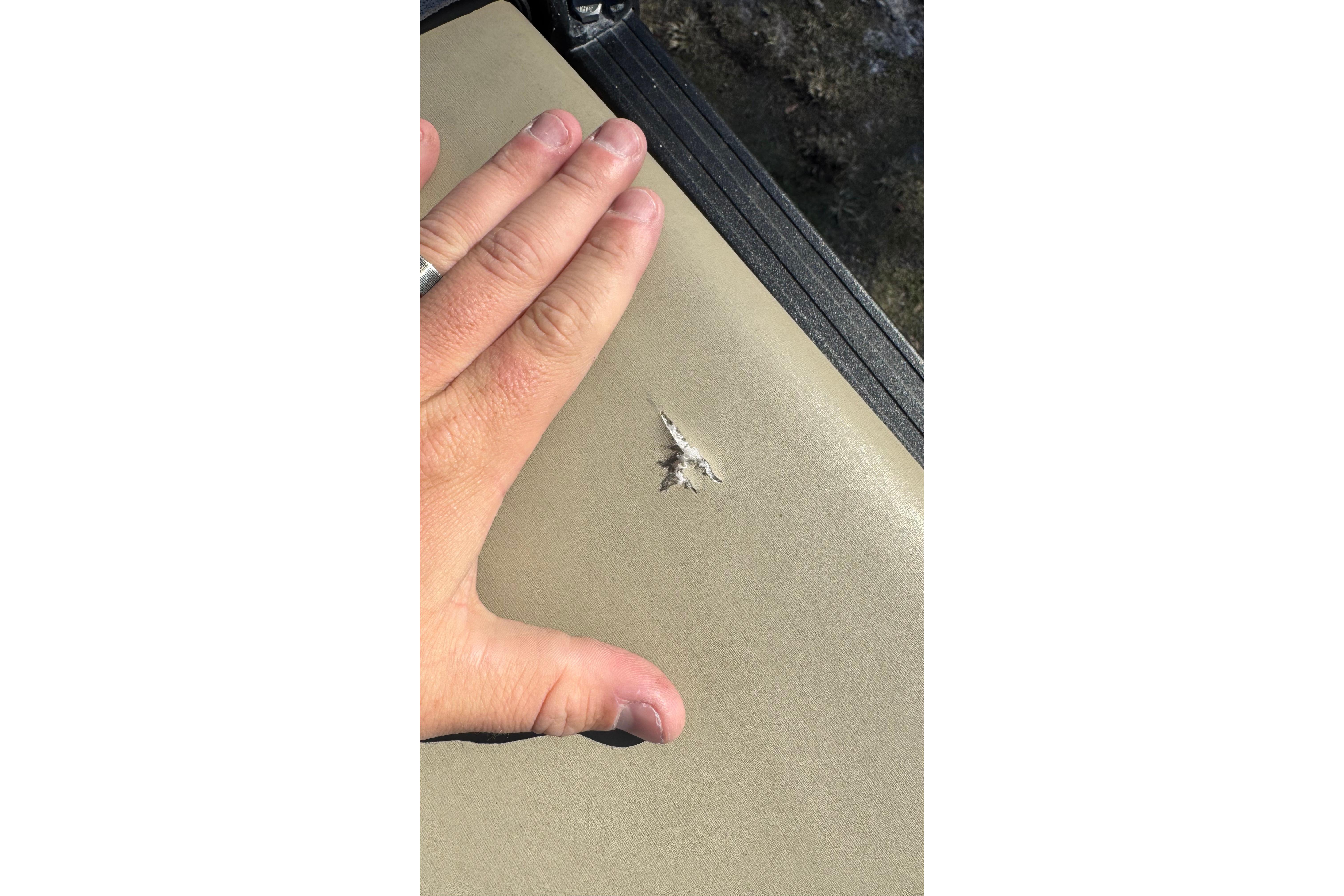 Hand showing damage on 2023 Sylvan L5 CLZ boat upholstery.