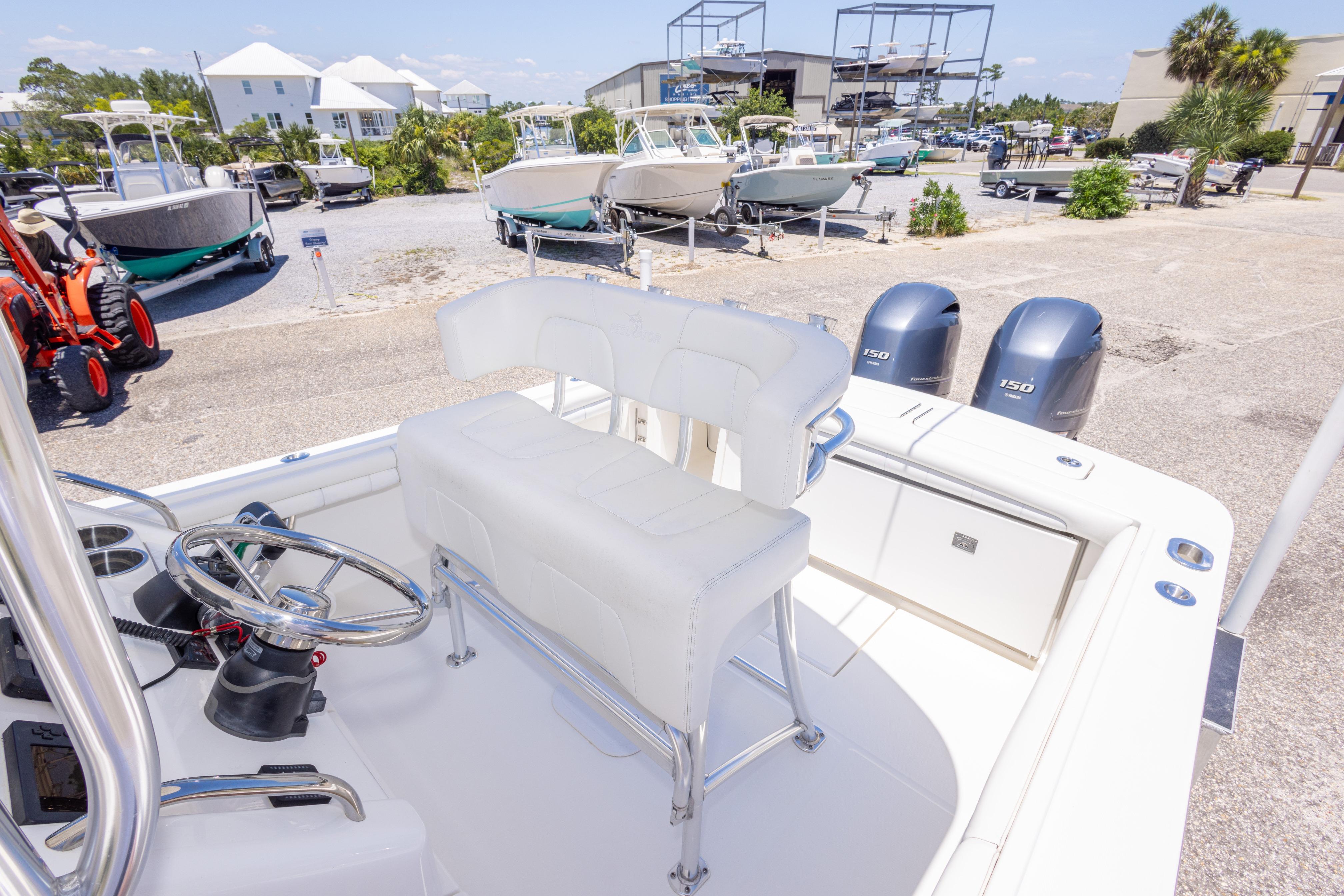 2019 Regulator 23 Center Console boat with dual engines in a marina setting.