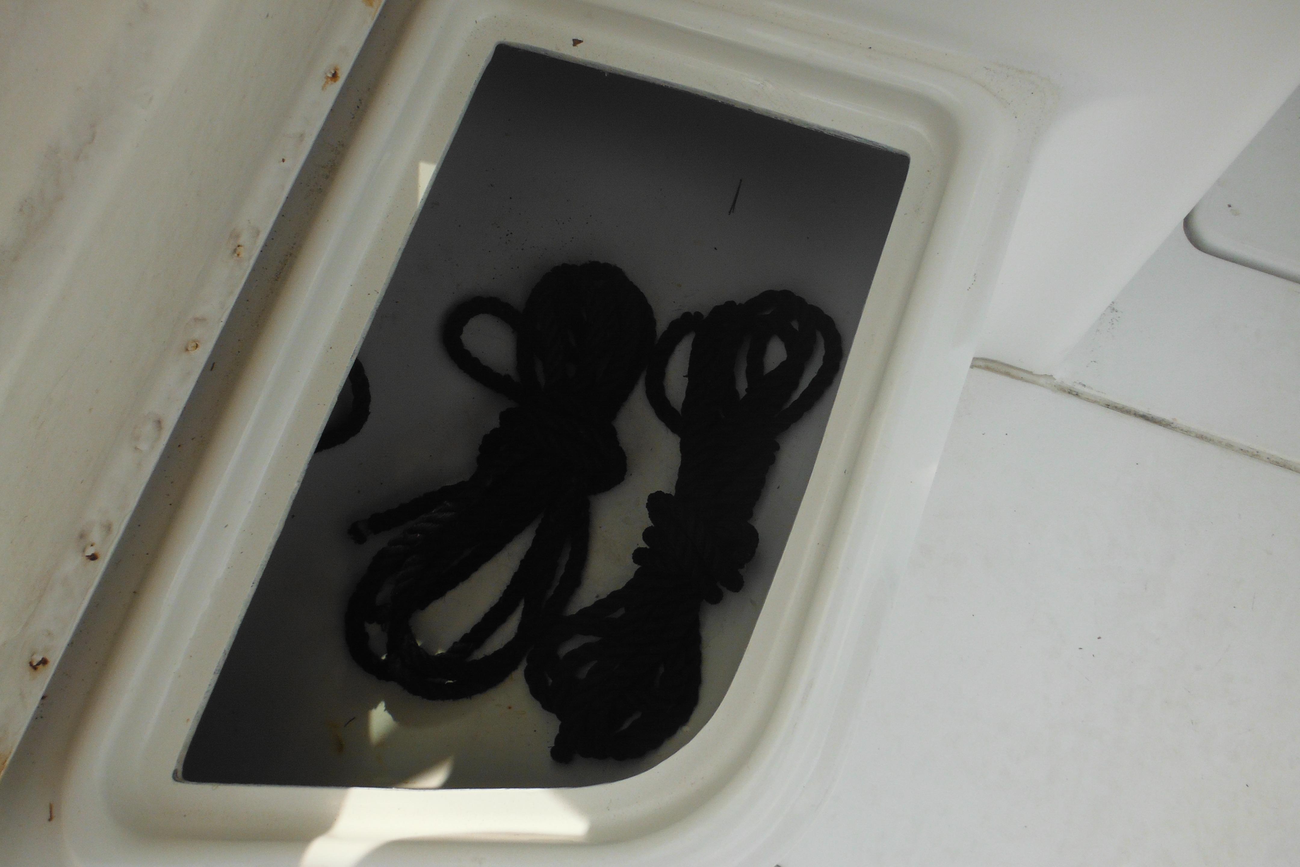 Storage compartment with coiled ropes on a 2005 Seaswirl Striper 2101 Walkaround O/B boat.