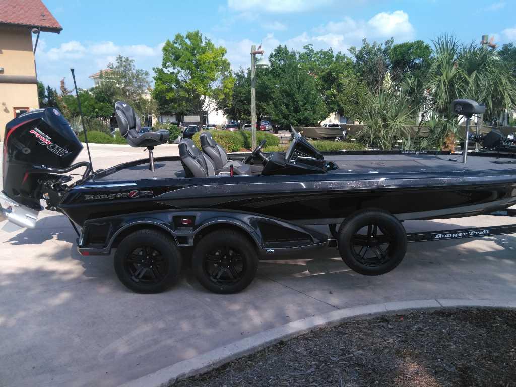 2025 Ranger Z521R Cup-Equipped boat on trailer, parked outdoors.