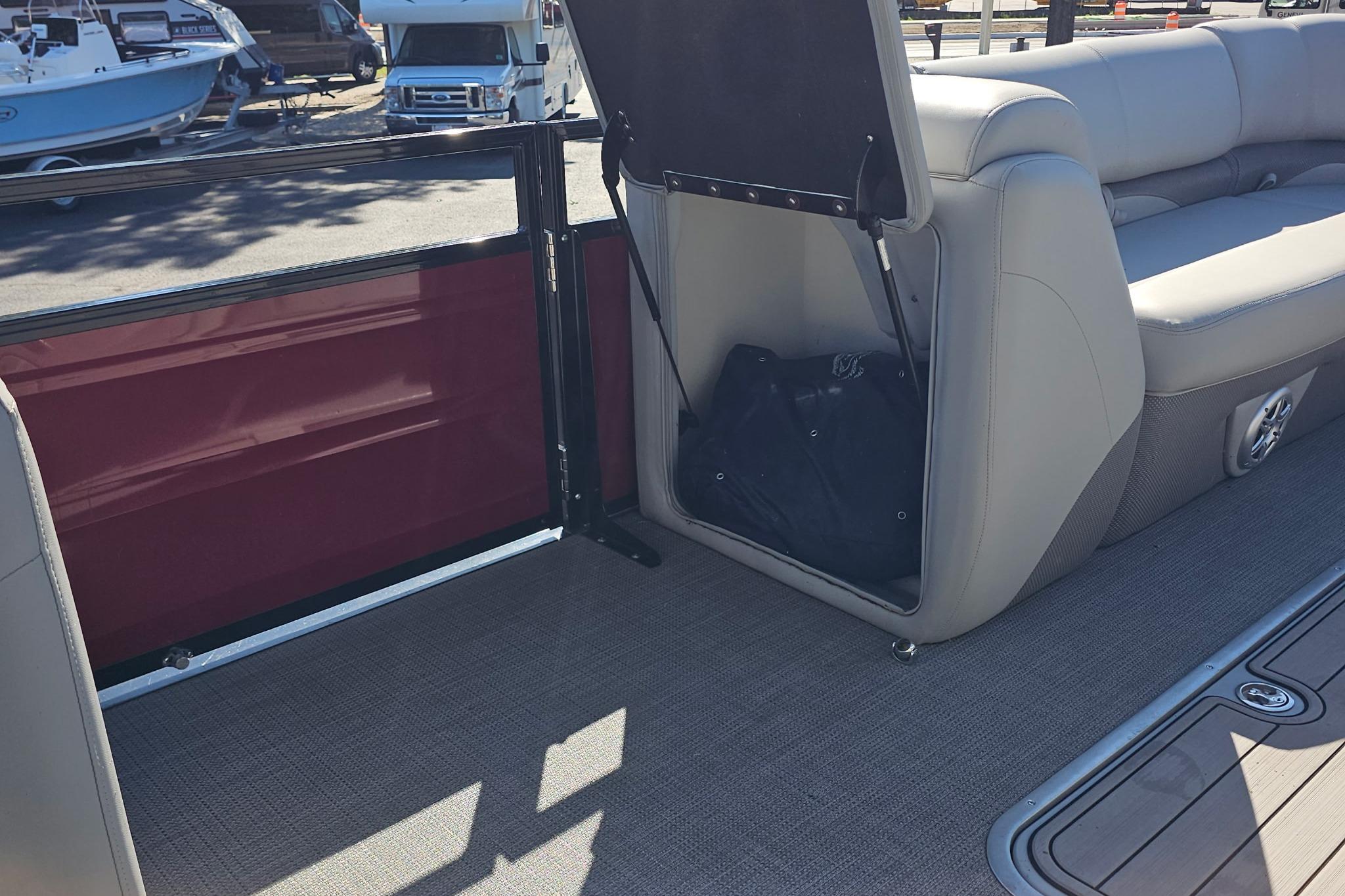 2023 Regency 250 DL3 boat interior with storage compartment and seating.