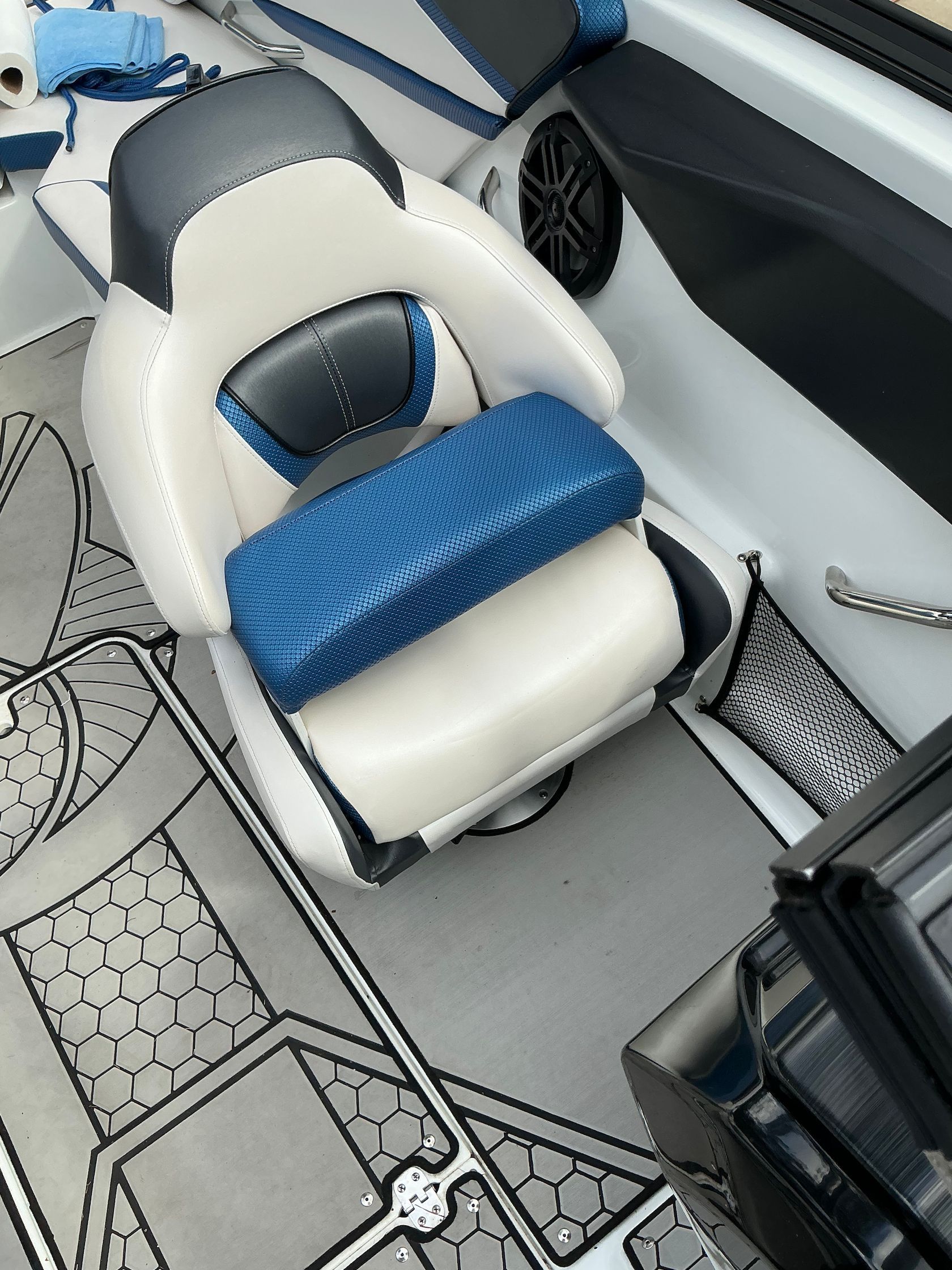 Interior of a Scarab 215 ID boat, seat with blue upholstery.