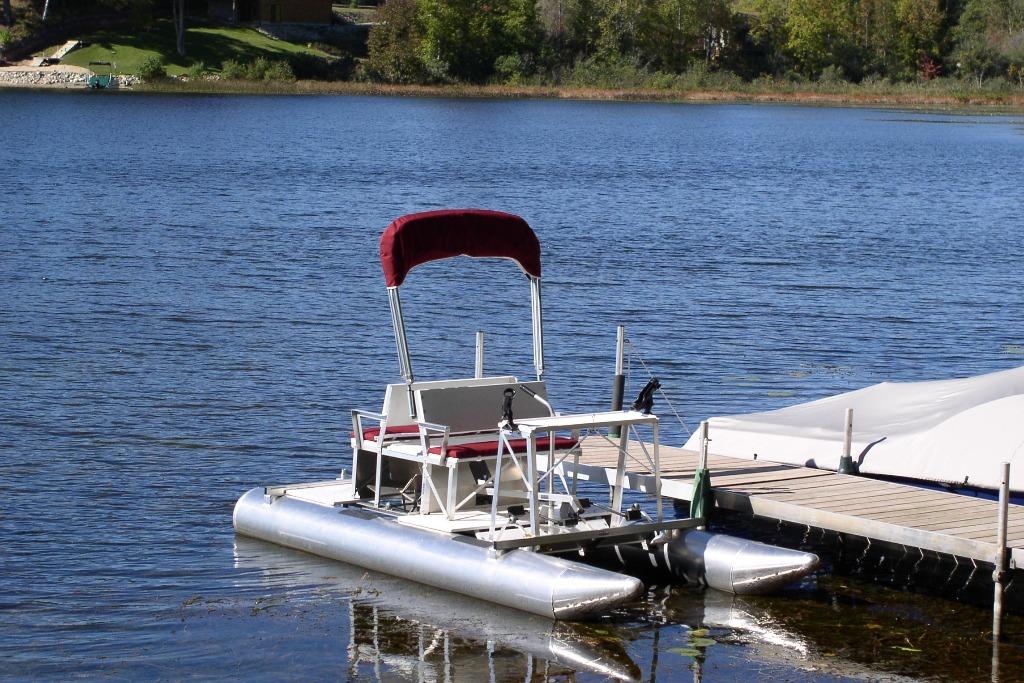 Aqua Cycle 2 pontoon boat docked on a serene lake, 2026 model.