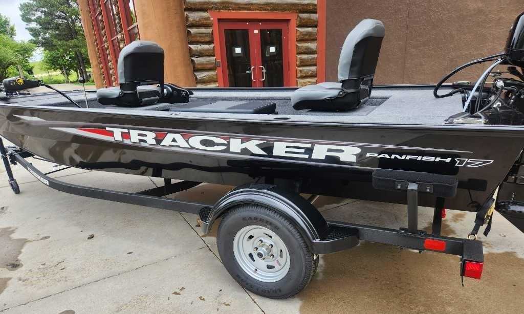 2025 Tracker Panfish 17 boat on trailer, black exterior, parked outdoors.