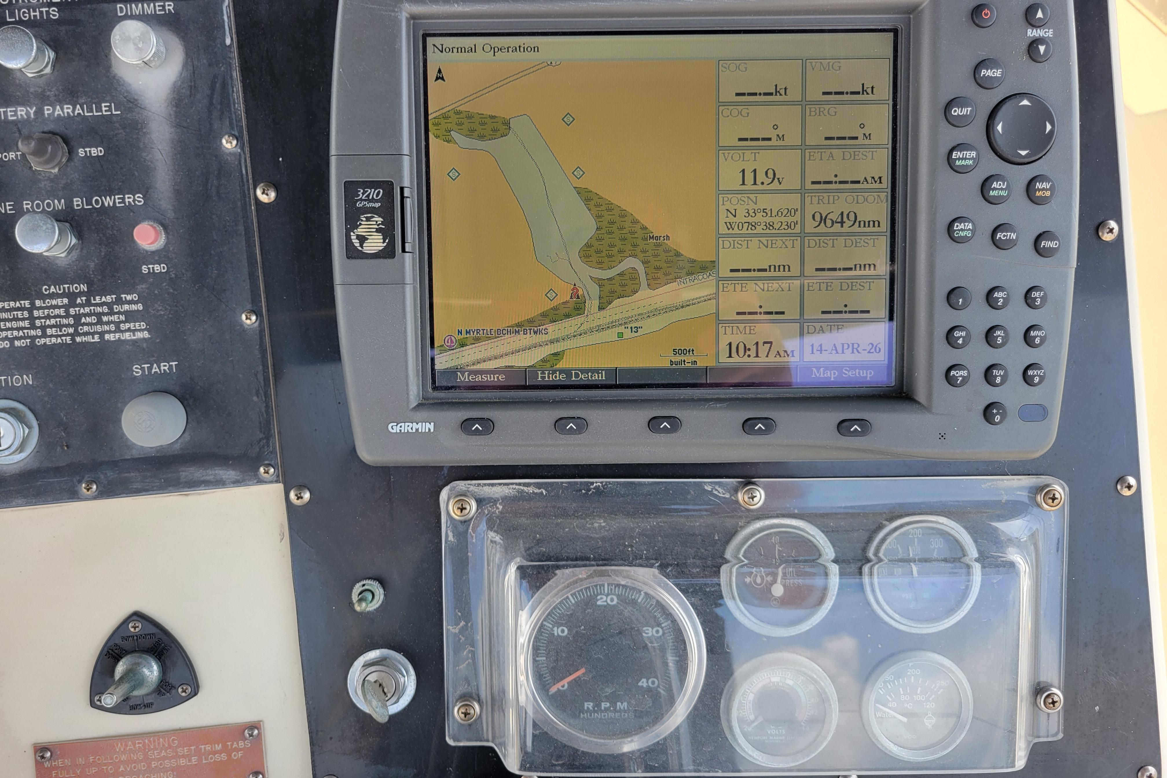 Control panel of a 1980 Hatteras 53 Yacht Fisherman with Garmin navigation display.