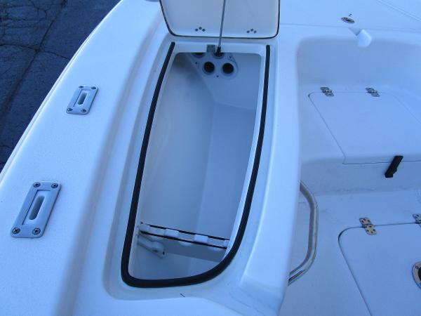 Open storage compartment on 2025 Sea Pro 230 Bay boat deck.