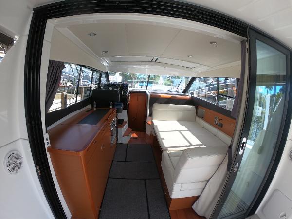 Interior of 2017 Jeanneau NC 11 boat with modern seating and helm station.