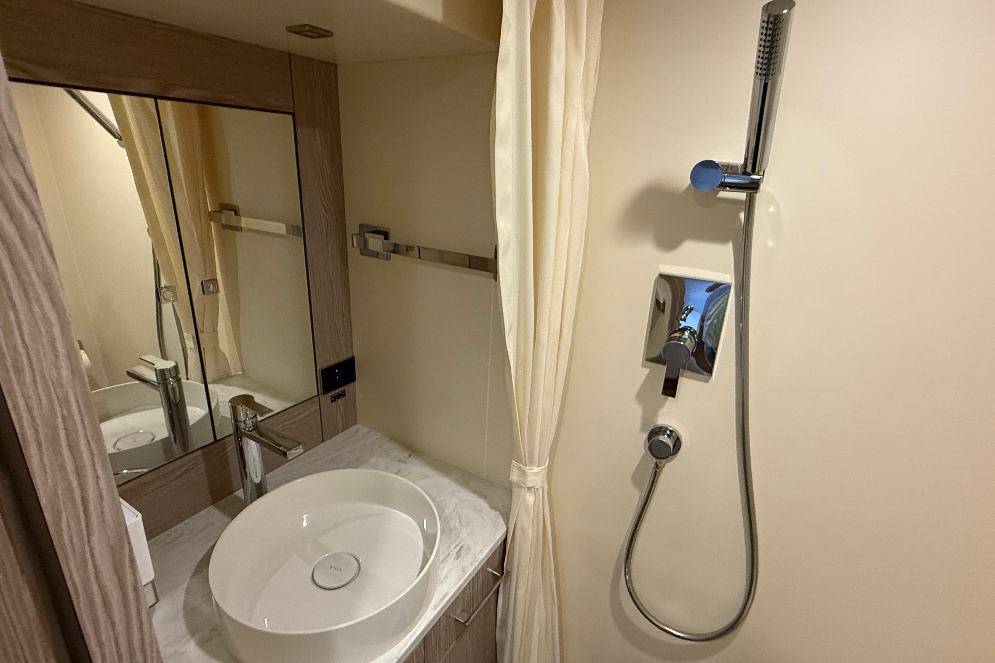 Luxurious bathroom in 2022 Sirena 58 yacht with modern sink and shower.